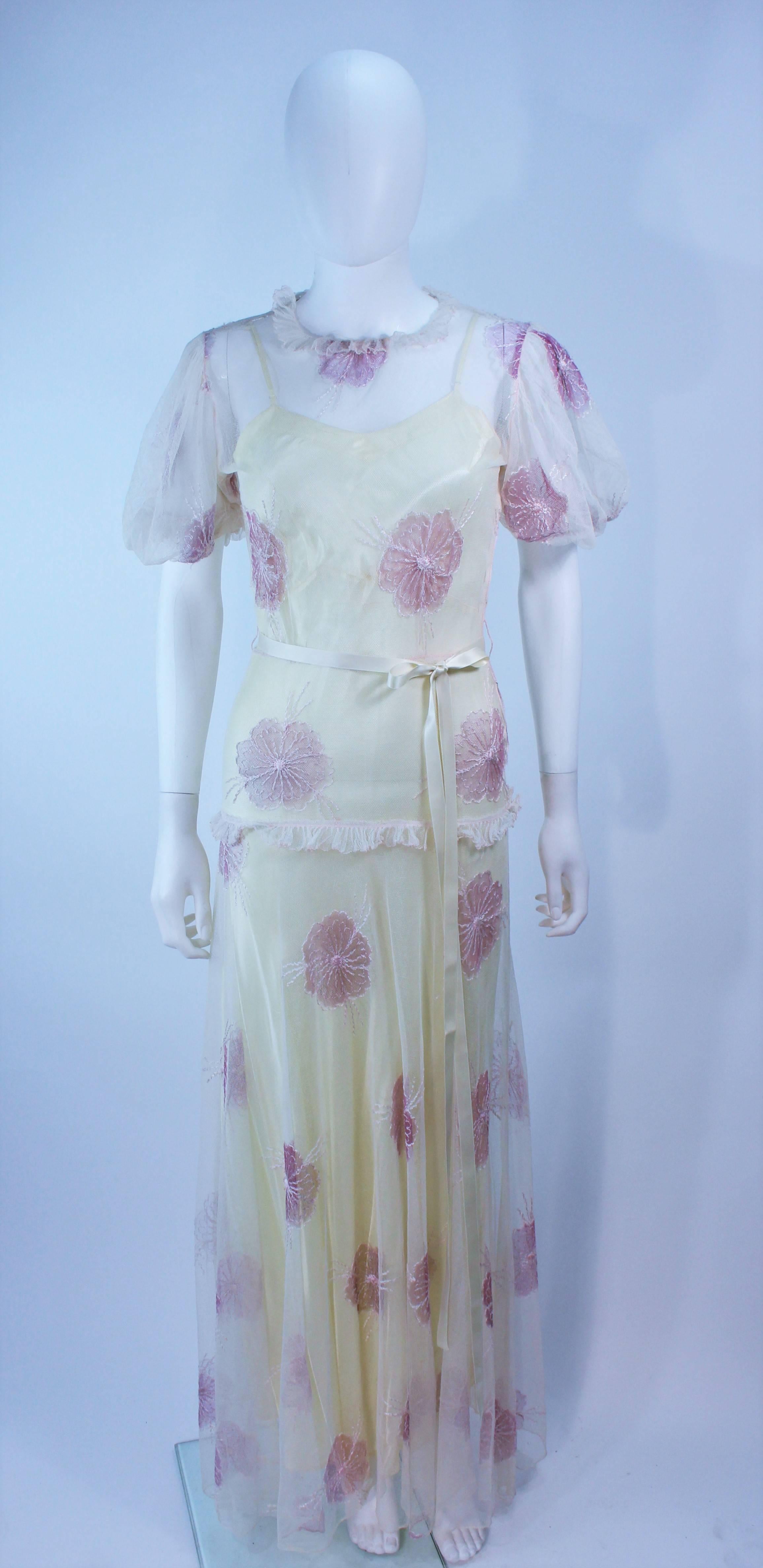  This gown is composed of 2 pieces, a sheer outer layer made of a floral patterned fabric with ruffle trim, as well as a yellow satin slip. Features a pullover style. In excellent vintage condition.

  **Please cross-reference measurements for