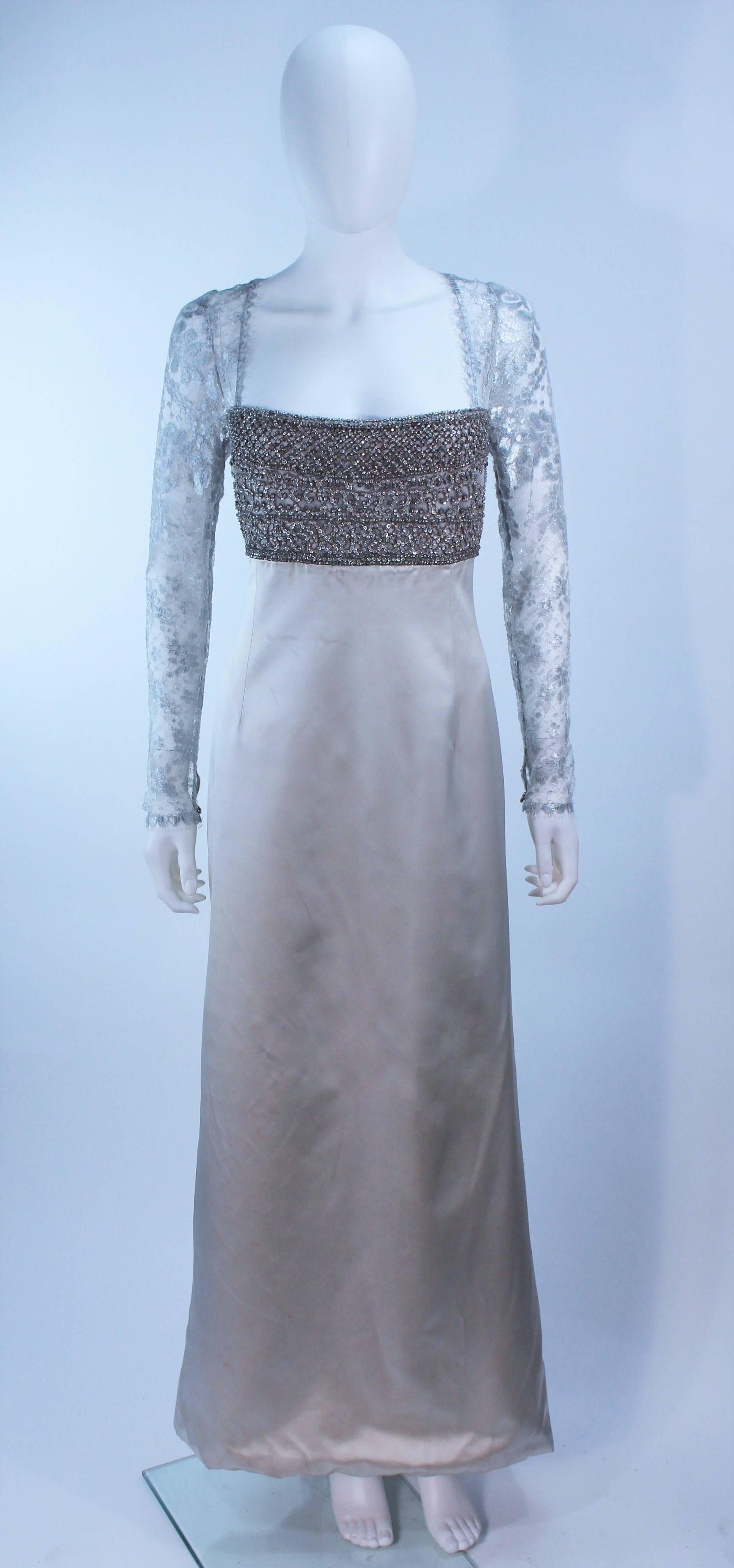 This Badgley Mischka dgown is composed of a silver lace with satin skirt, and a beaded bodice. Features a sheer lace metallic sleeves. There is a center back zipper closure. In excellent pre-owned condition.

  **Please cross-reference