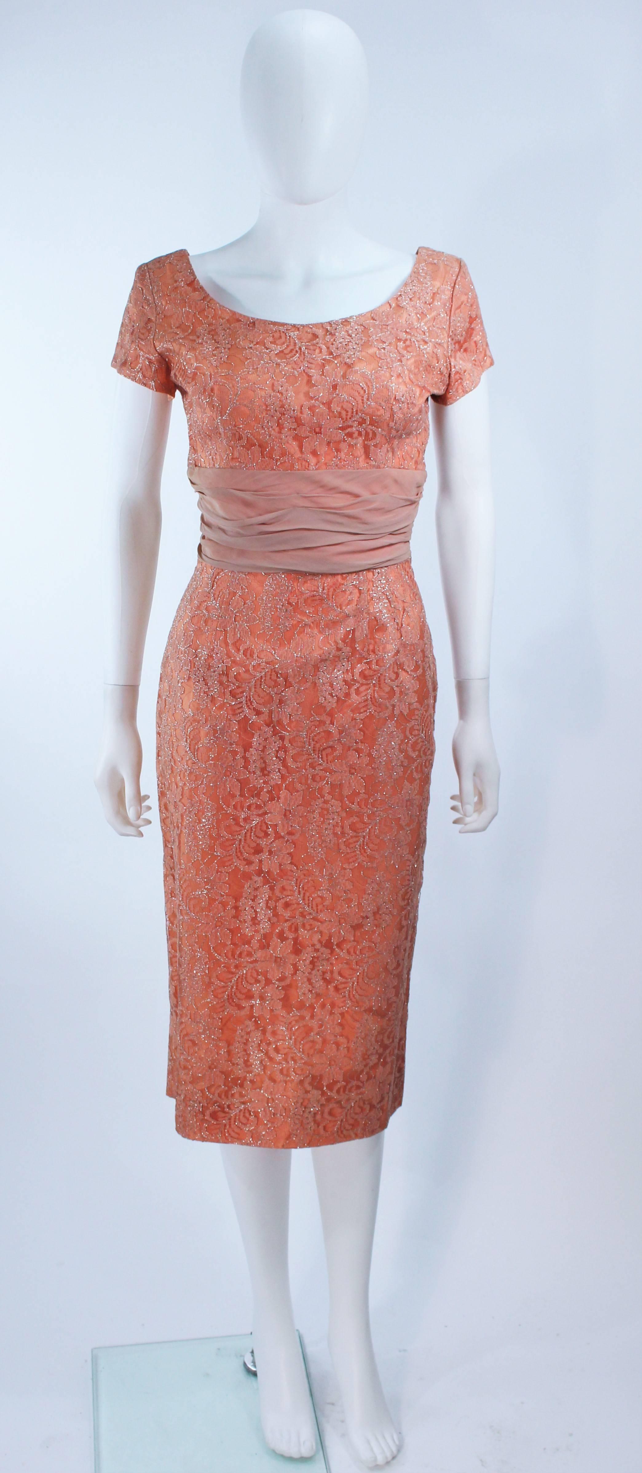  This cocktail dress is composed of a metallic peach hue lace. Features a gathered chiffon waist. There is a center back zipper closure. In great vintage condition.

  **Please cross-reference measurements for personal accuracy. Size in