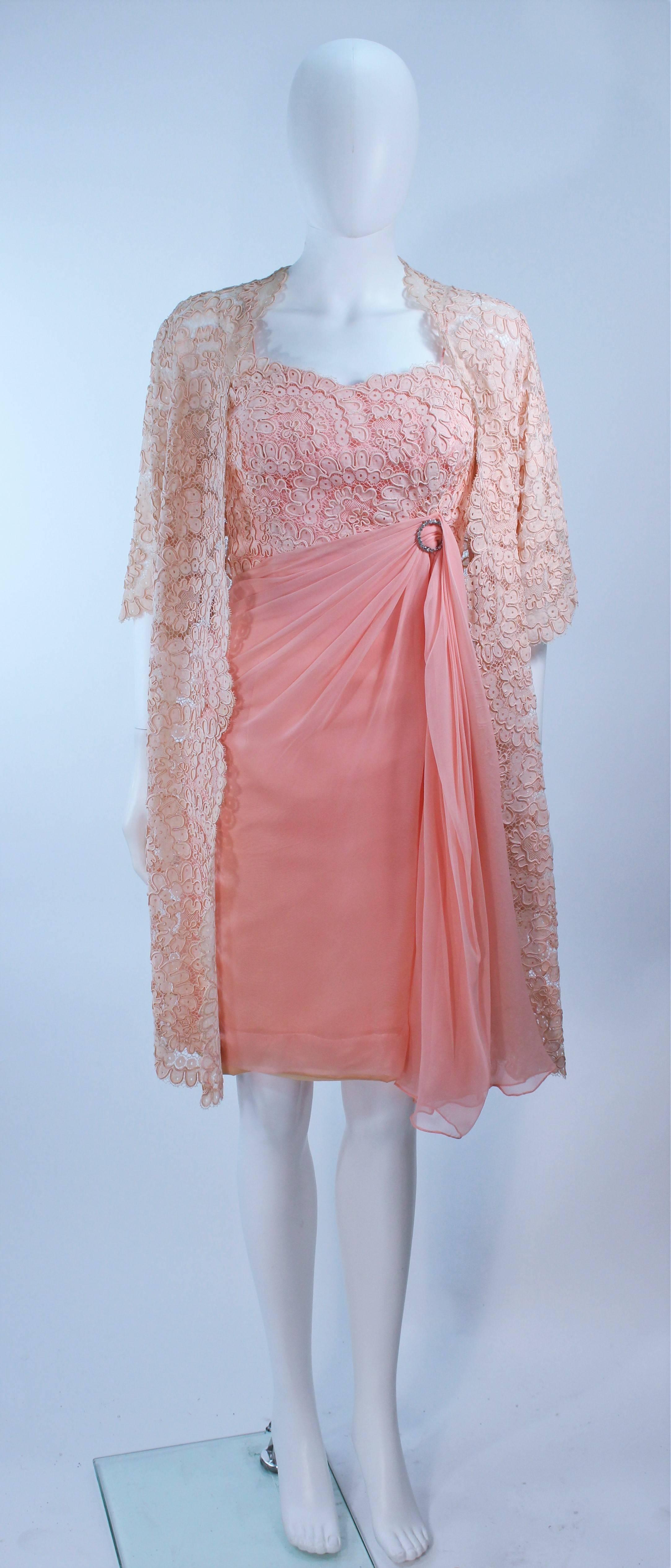  This ensemble is composed of a pink hue combination of lace and chiffon The dress features a lace bodice with a chiffon skirt. There is a center back zipper closure. The coat is an open style. In great vintage condition.

  **Please