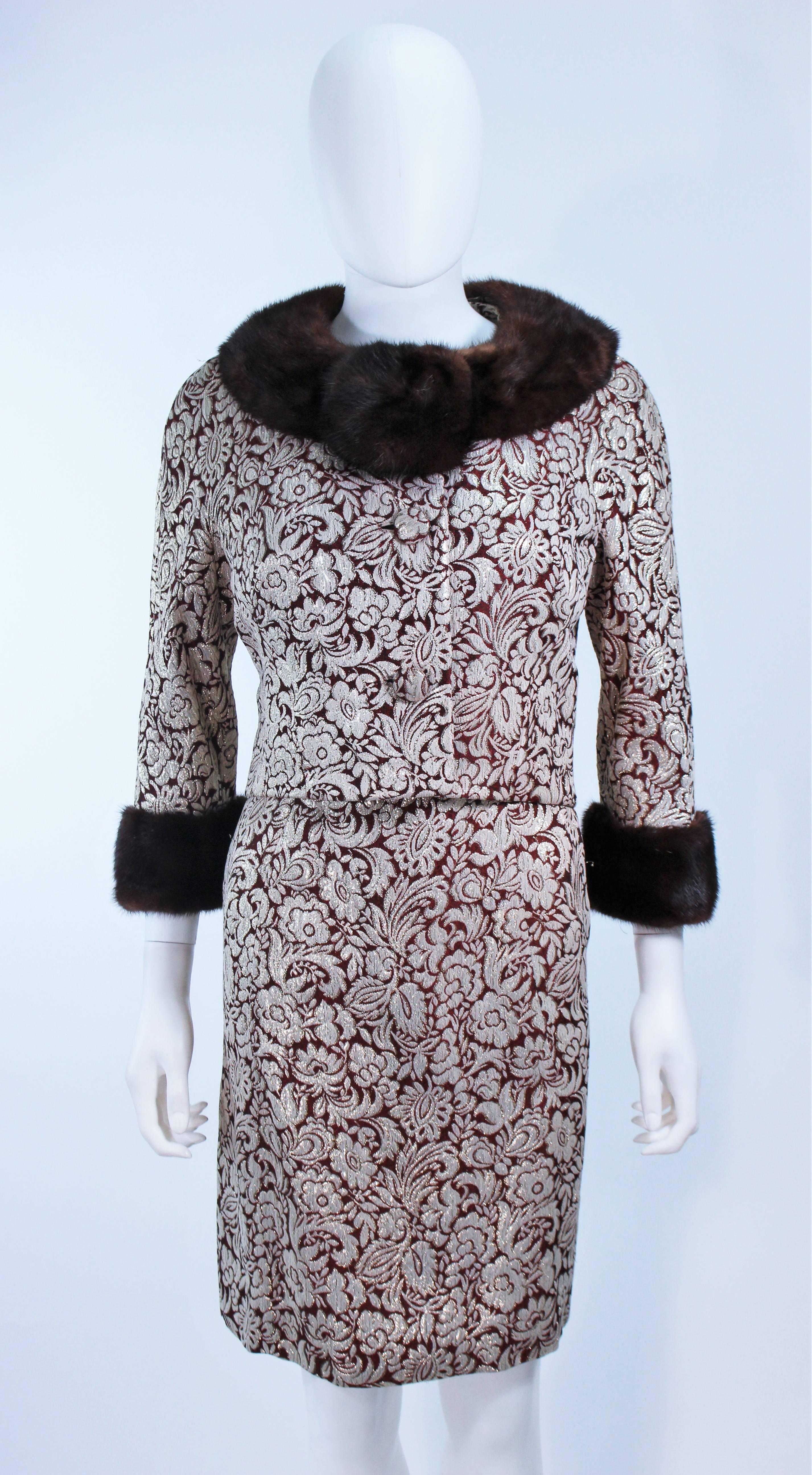  This ensemble is composed of a burgundy and metallic floral brocade with mink trim. The jacket has center front closures, and the dress has a center back zipper closure. In great vintage condition.

  **Please cross-reference measurements for