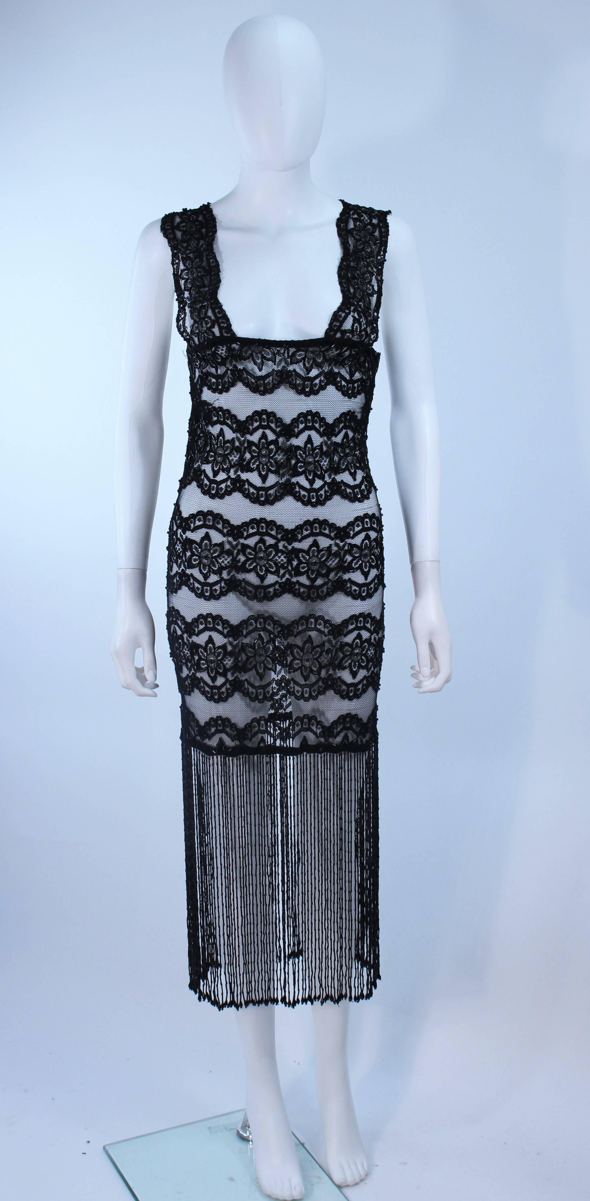  This custom made dress is composed of a stretch black lace with a long fringe hem trim. Features a zipper closure. In great vintage condition.

  **Please cross-reference measurements for personal accuracy. Size in description box is an