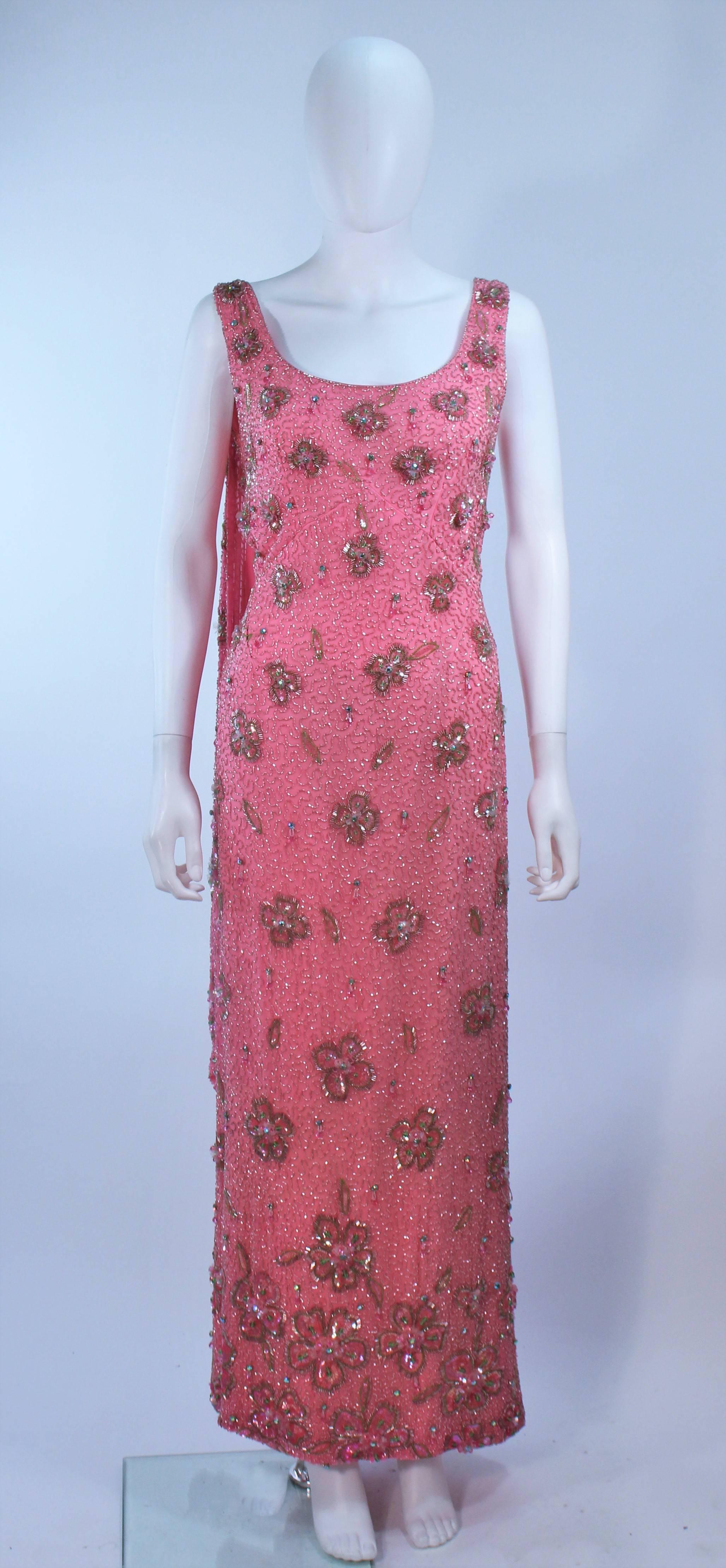 This Maxwell Shieff  gown is composed of a pink embellished silk, with rhinestone and bead applique. There is a center back zipper and drape. In excellent vintage condition.

  **Please cross-reference measurements for personal accuracy. Size in