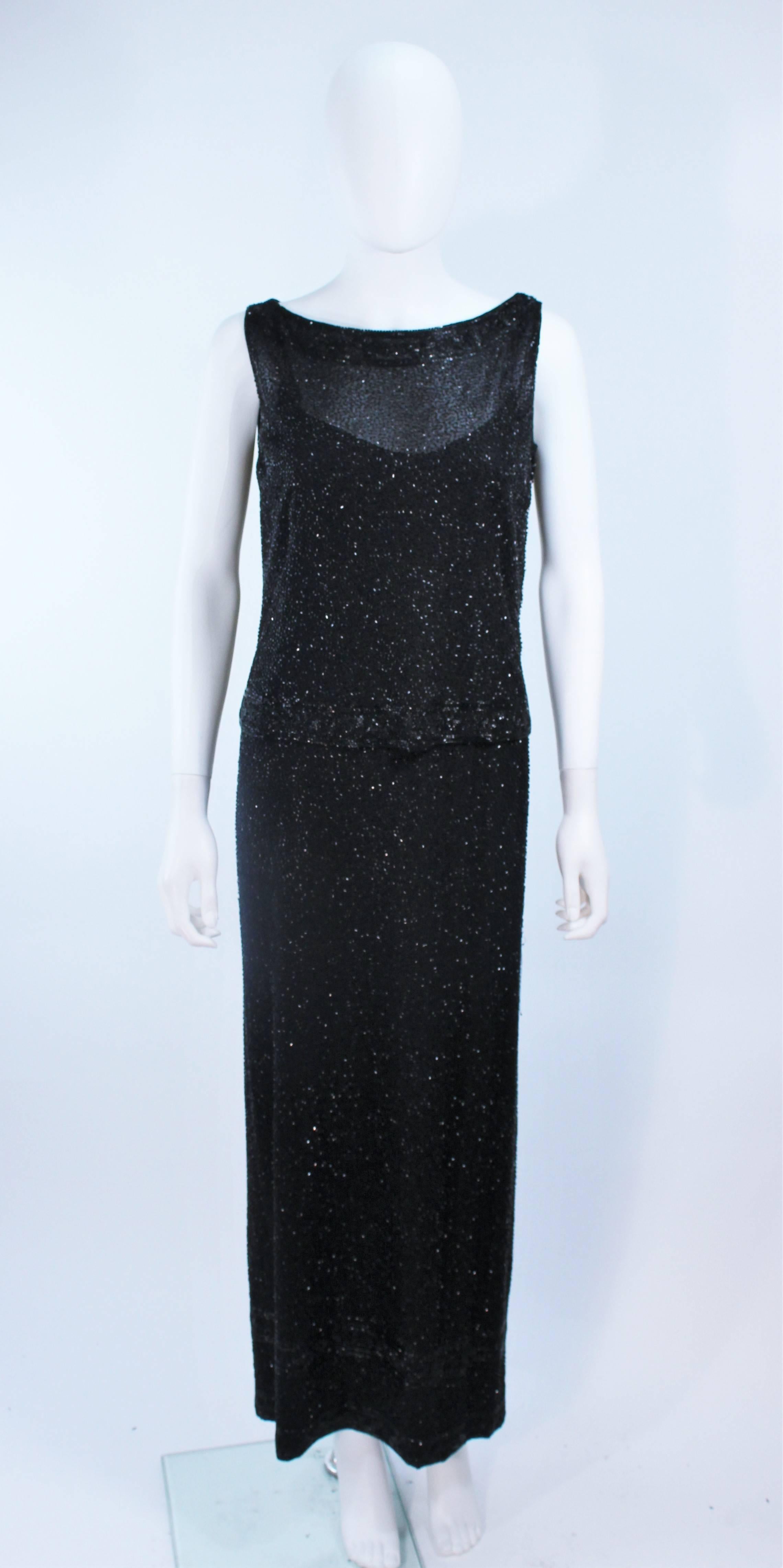 This Ceil Chapman  ensemble is composed of a beaded black silk. Features an outer shell top and interior dress with zipper closure. Excellent design.

  **Please cross-reference measurements for personal accuracy. Size in description box is an