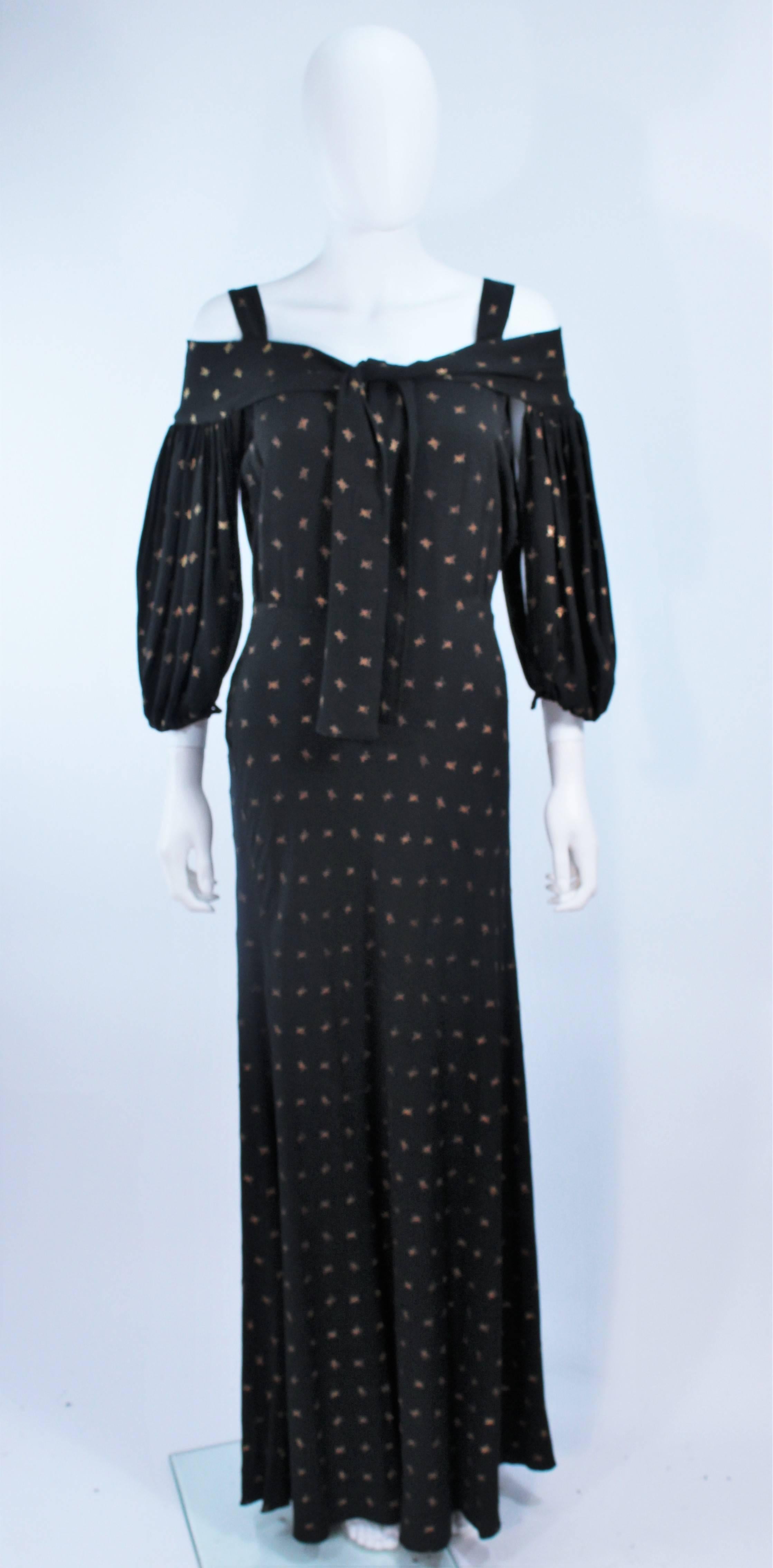 This gown is composed of a black and gold fabric. Features a tie front which crosses the shoulders to create a flowing sleeve. There are side snap closures. In excellent vintage condition.

  **Please cross-reference measurements for personal