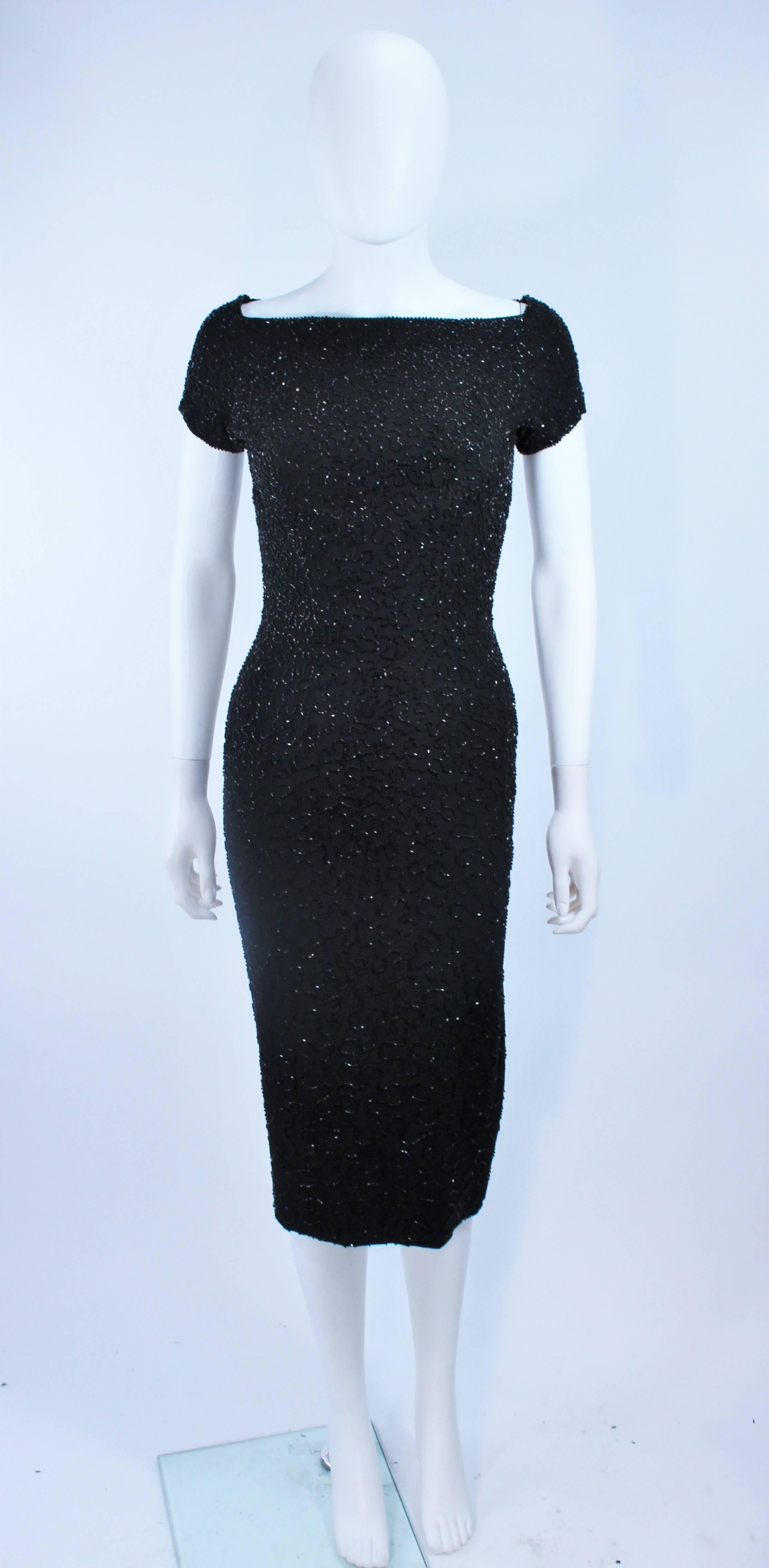 
 This cocktail dress is composed of a beaded black silk. Features a square neckline with center back zipper. Excellent vintage condition.

  **Please cross-reference measurements for personal accuracy. Size in description box is an
