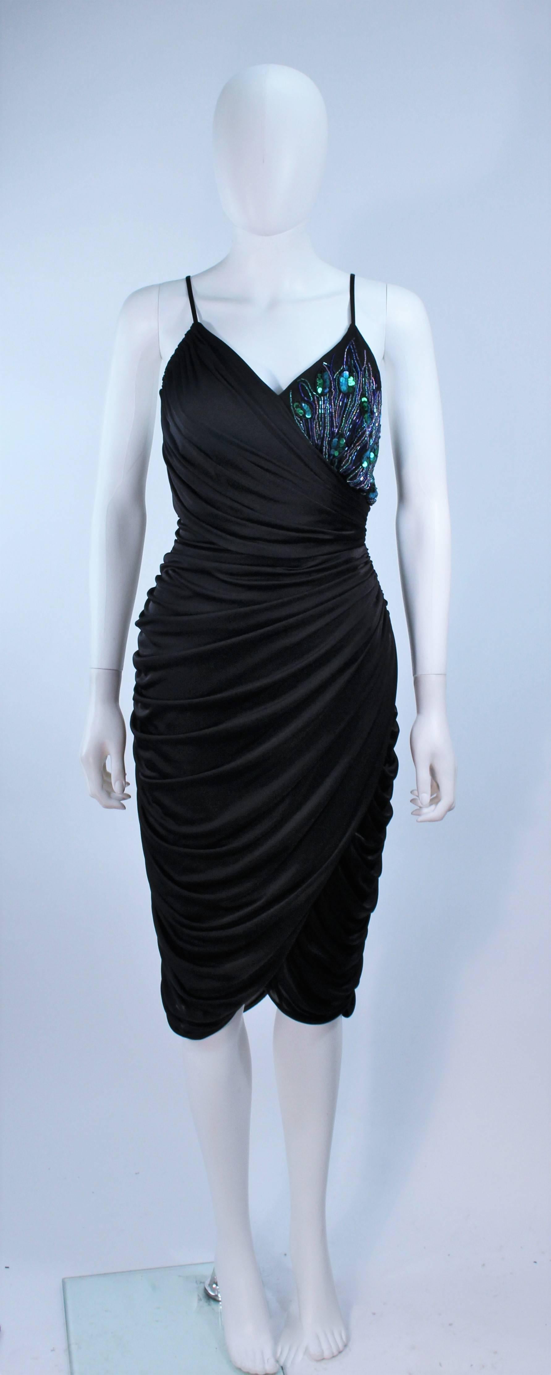 This Alley Kent cocktail dress is composed of a black draped jersey with iridescent sequin applique. There is a center back zipper closure. Excellent vintage condition.

  **Please cross-reference measurements for personal accuracy. Size in