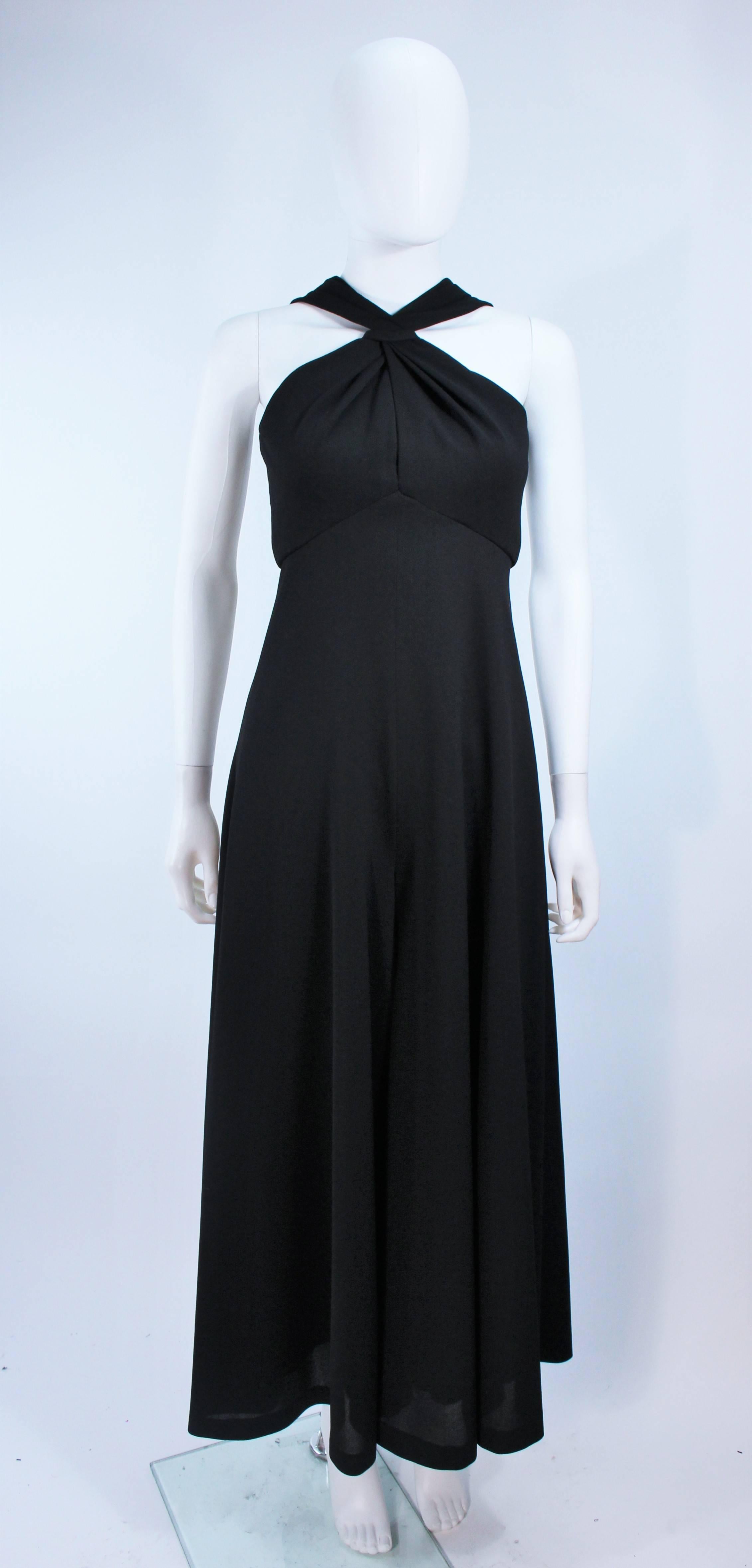  This jumpsuit is composed of a black crepe. Features a criss cross front detail and center back zipper closure. Excellent vintage condition.

  **Please cross-reference measurements for personal accuracy. Size in description box is an