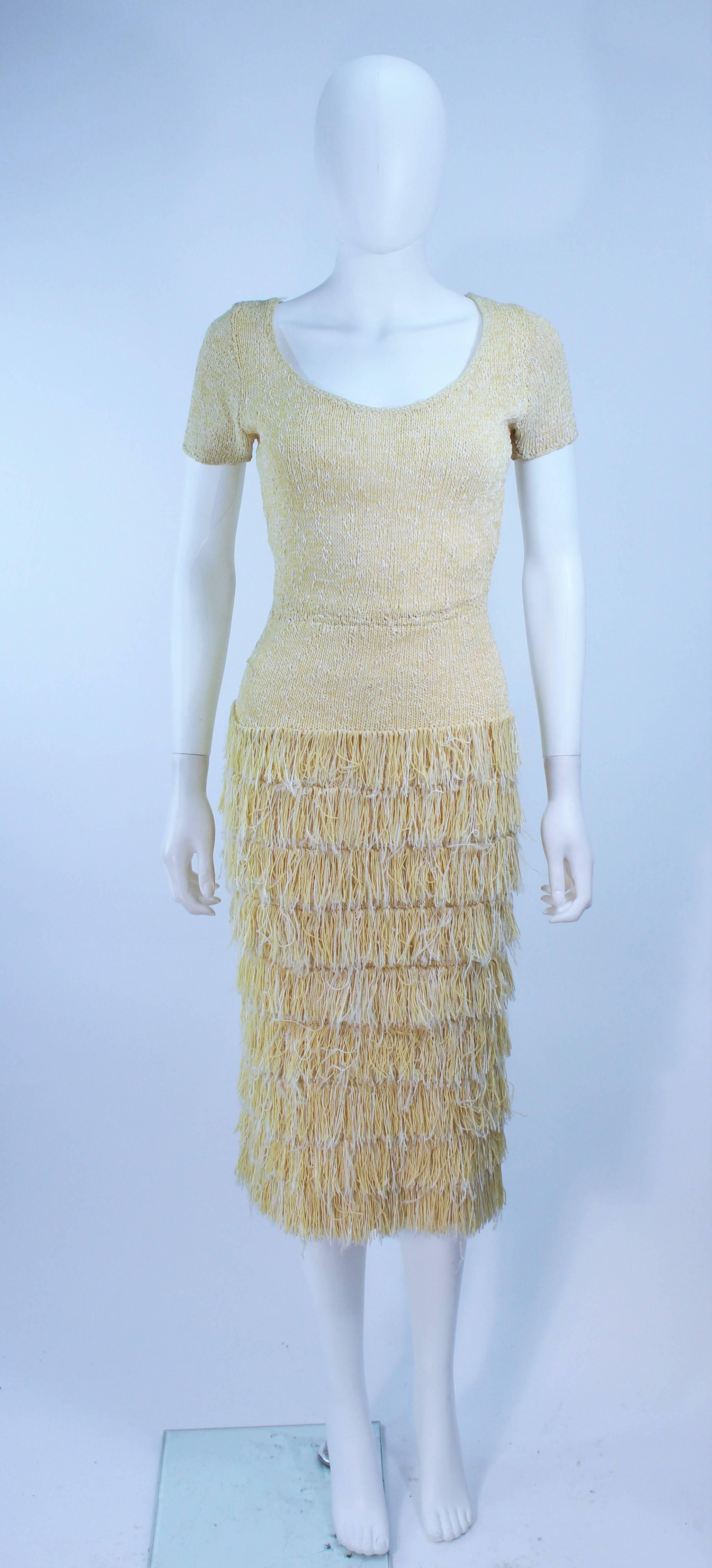 This Sydney's of Beverly Hills cocktail dress is composed of a yellow stretch hand knit. Features a fringe detail. In excellent vintage condition.

**Please cross-reference measurements for personal accuracy. Size in description box is an