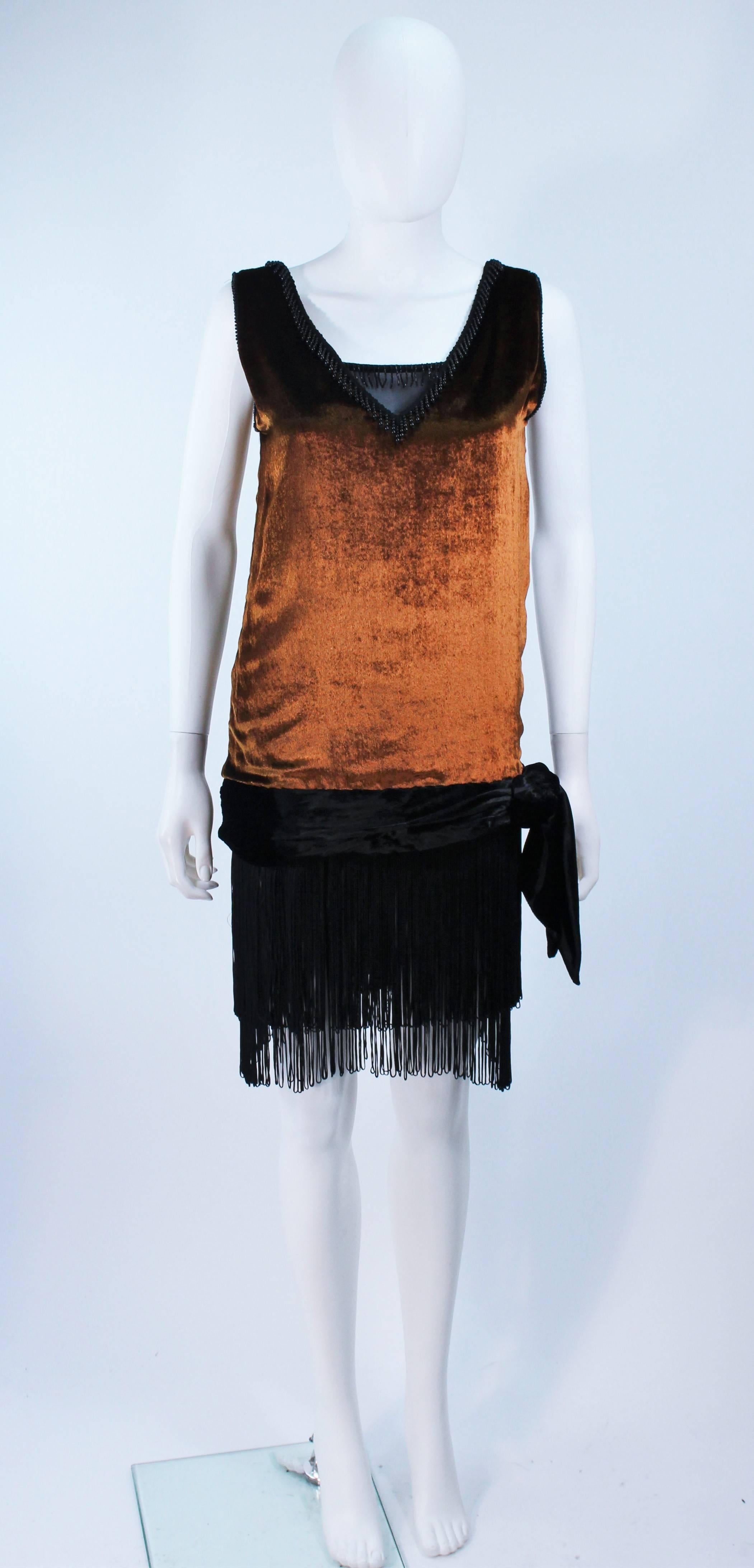 This David Fielden dress is composed of an orange gradient velvet with beaded fringe trim. Features an exterior shell and slip. In excellent vintage condition.

**Please cross-reference measurements for personal accuracy. Size in description box