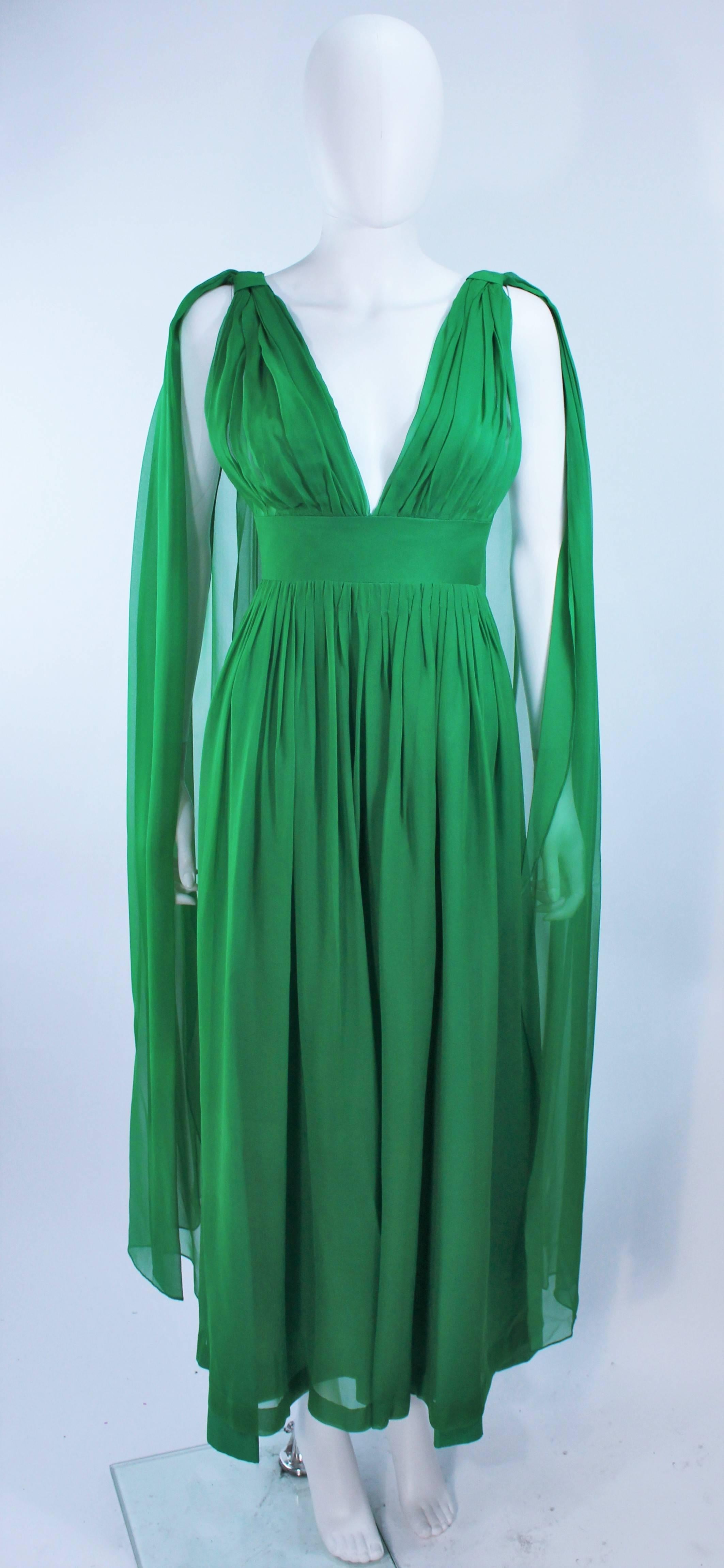 This gown is composed of  green chiffon. Features a gathered bust with draped shoulder details. There is a center back zipper closure. In excellent vintage condition.

**Please cross-reference measurements for personal accuracy. Size in