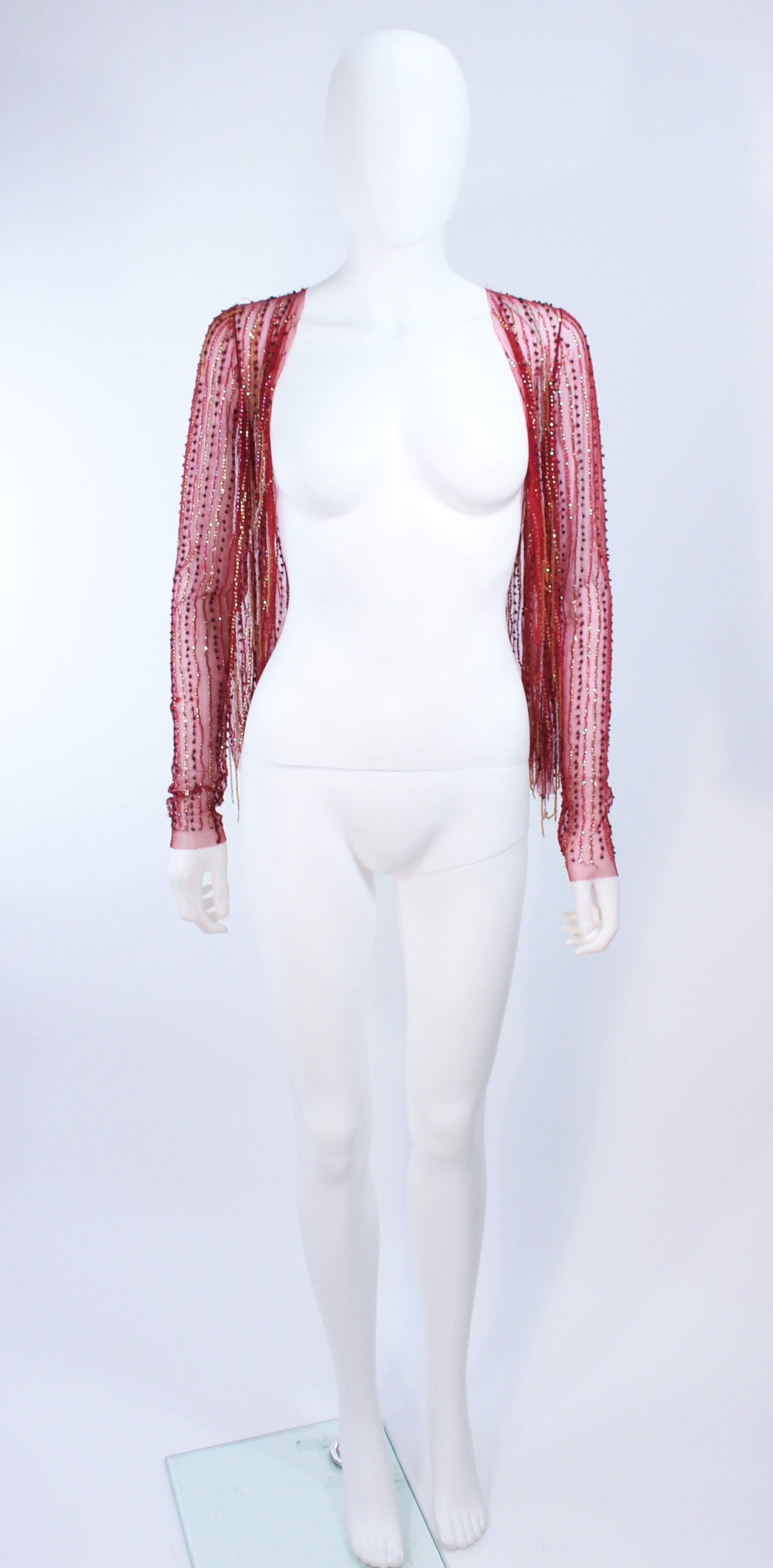 This top is composed of a stretch red mesh with beaded fringe applique. Features an open style. In excellent vintage condition.

**Please cross-reference measurements for personal accuracy. Size in description box is an estimation.

Measures