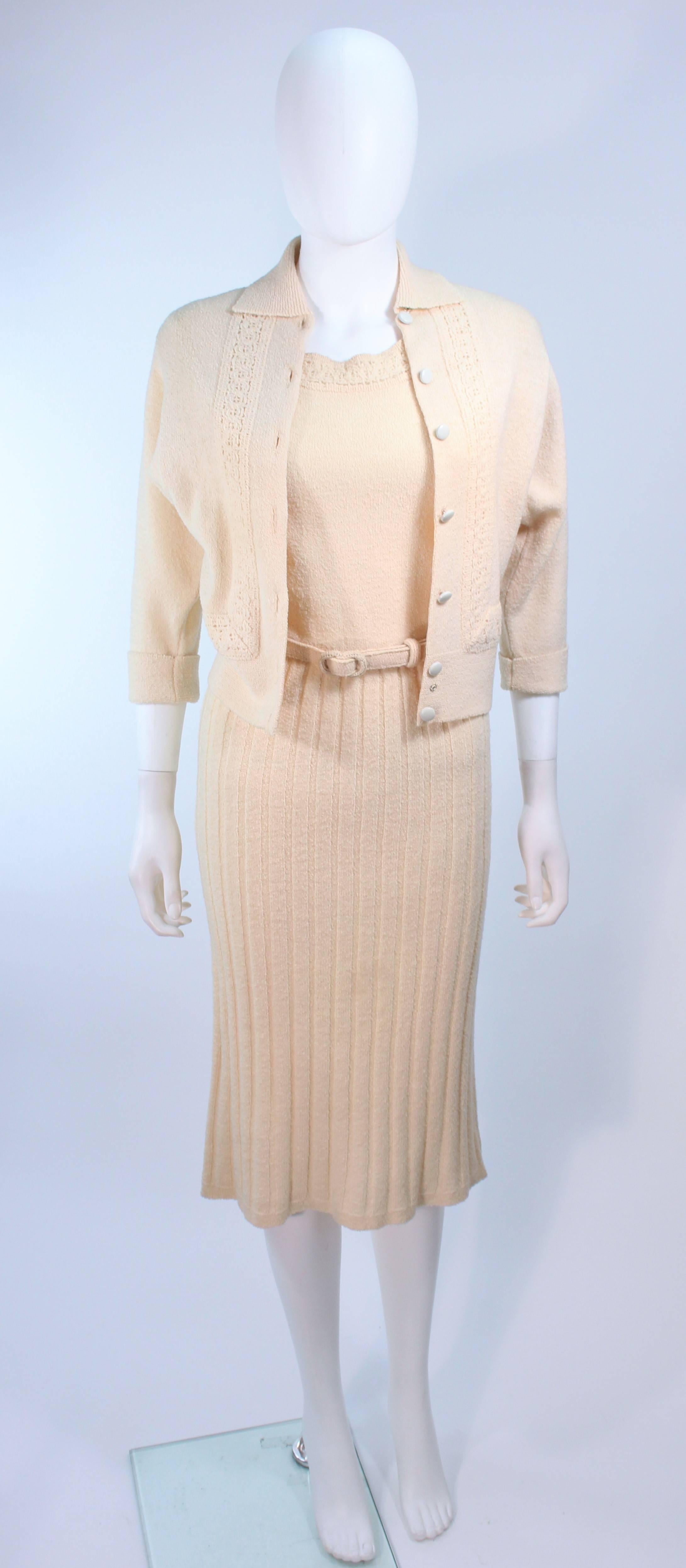 This ensemble is composed of an ivory stretch Zephyr wool . The sweater features center front button closures. Comes with belt. In excellent vintage condition.

**Please cross-reference measurements for personal accuracy. Size in description box