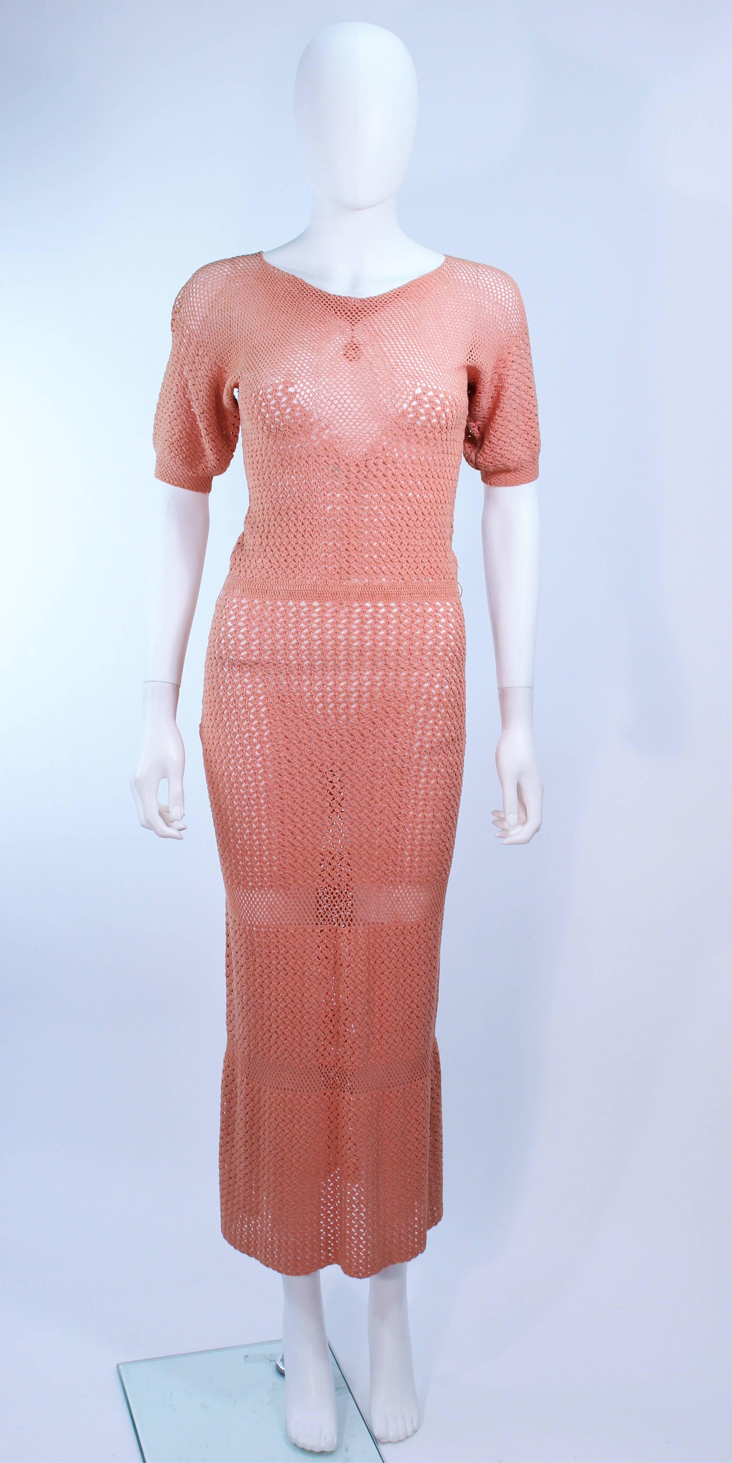 This gown is composed of a terracotta hue knit. Features a draped neckline and tea length. In excellent condition.

**Please cross-reference measurements for personal accuracy. Size in description box is an estimation.

Measures