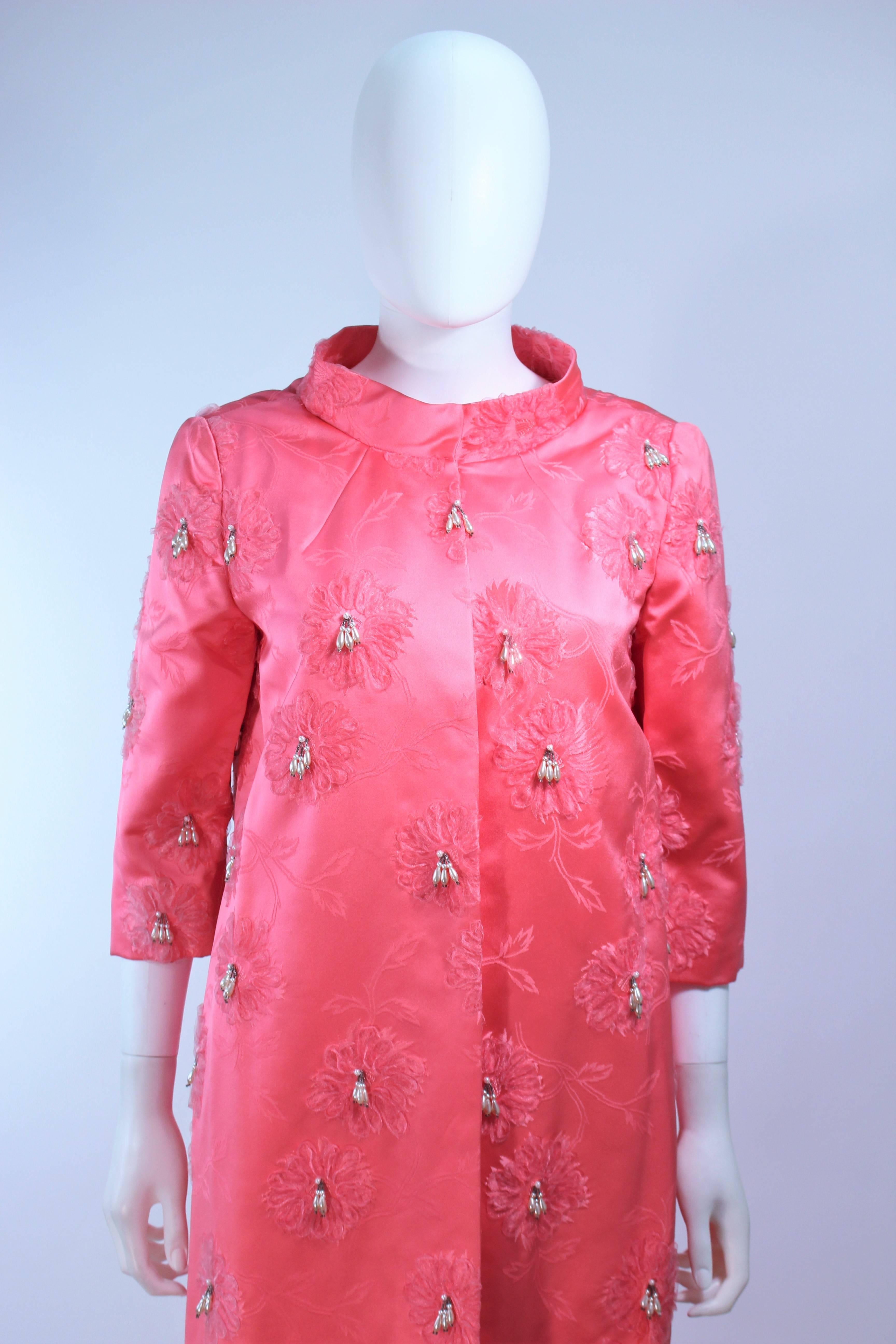 This coat is composed of a vibrant pink silk with faux pearl applique and bow design. Features center front hook and eye closures and belt. In excellent vintage condition.

**Please cross-reference measurements for personal accuracy. Size in