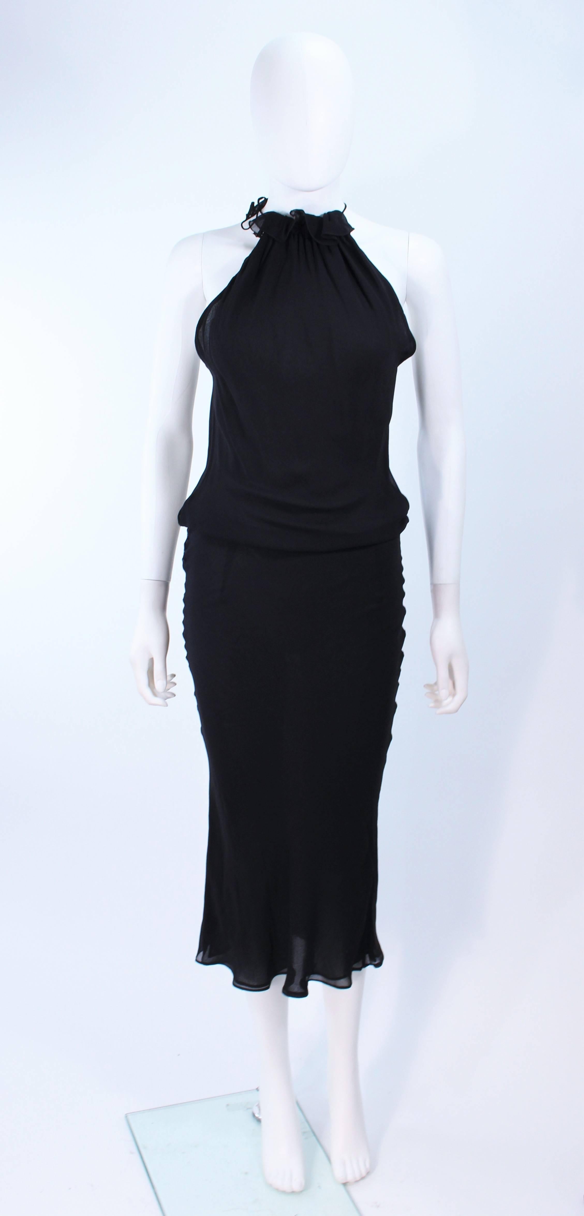 This Ungaro dress is composed of a bias cut black silk. Features ruffle halter neck and side snap closures. In excellent vintage condition.

**Please cross-reference measurements for personal accuracy. Size in description box is an