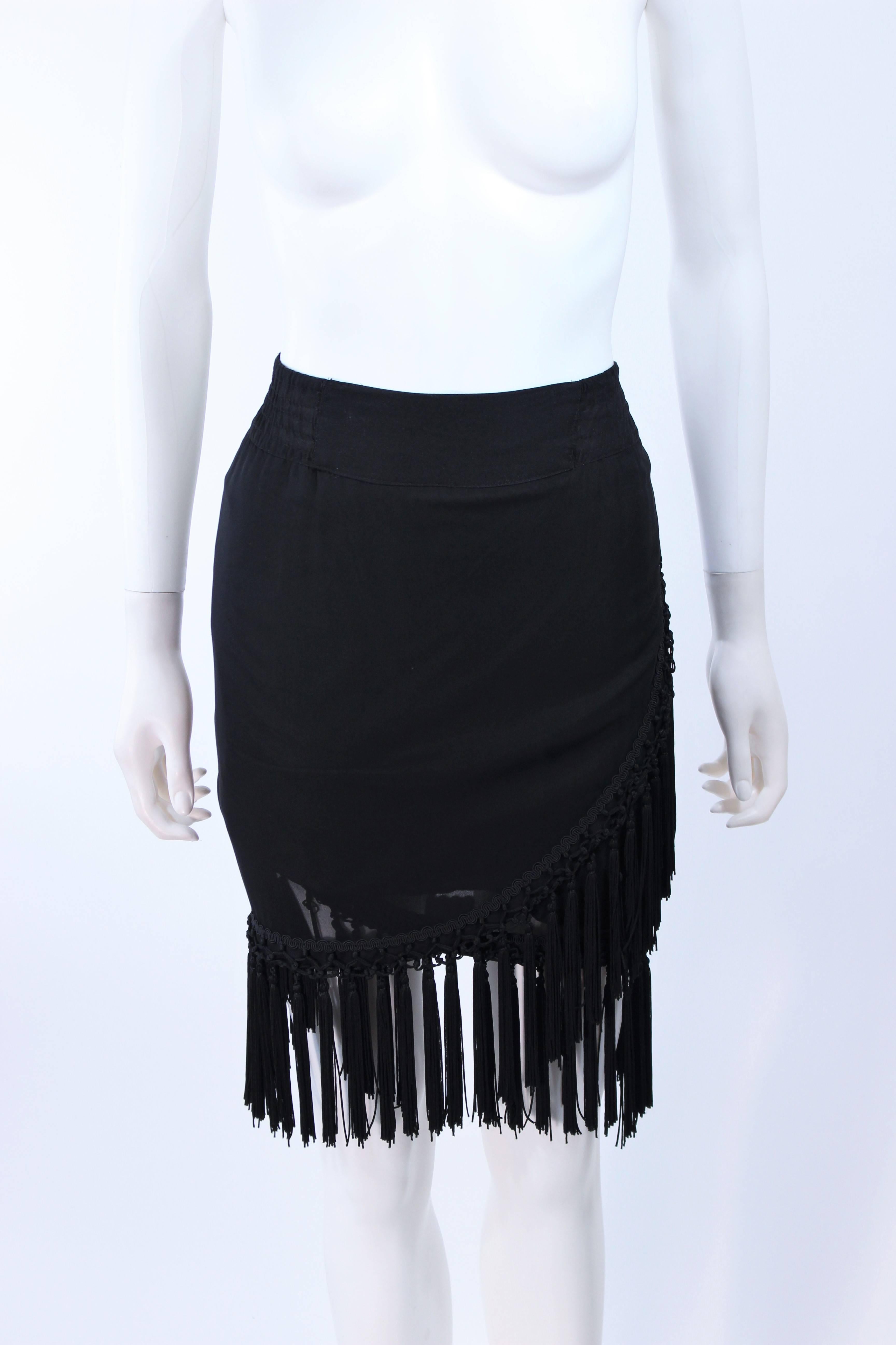 This Diane Frez design is composed of a black silk chiffon and features a tassel trim. Wrap style with elastic waist. In excellent vintage condition.

**Please cross-reference measurements for personal accuracy. Size in description box is an