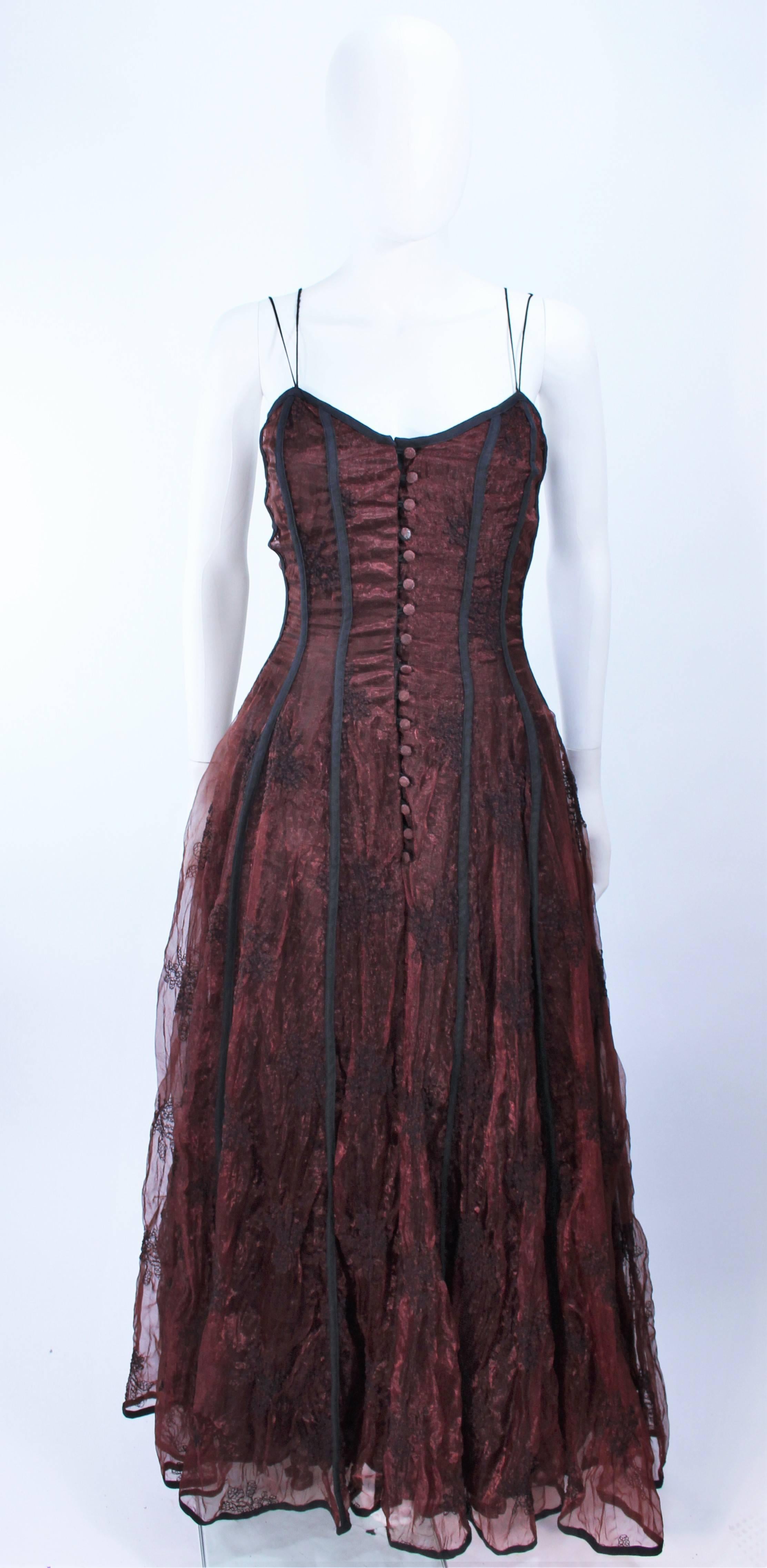 This Kaat Tilly gown is composed of a brown crinkled lace and features a black trim. Corset style with center front button closures. In excellent vintage condition, with original tags, possibly unworn.

**Please cross-reference measurements for