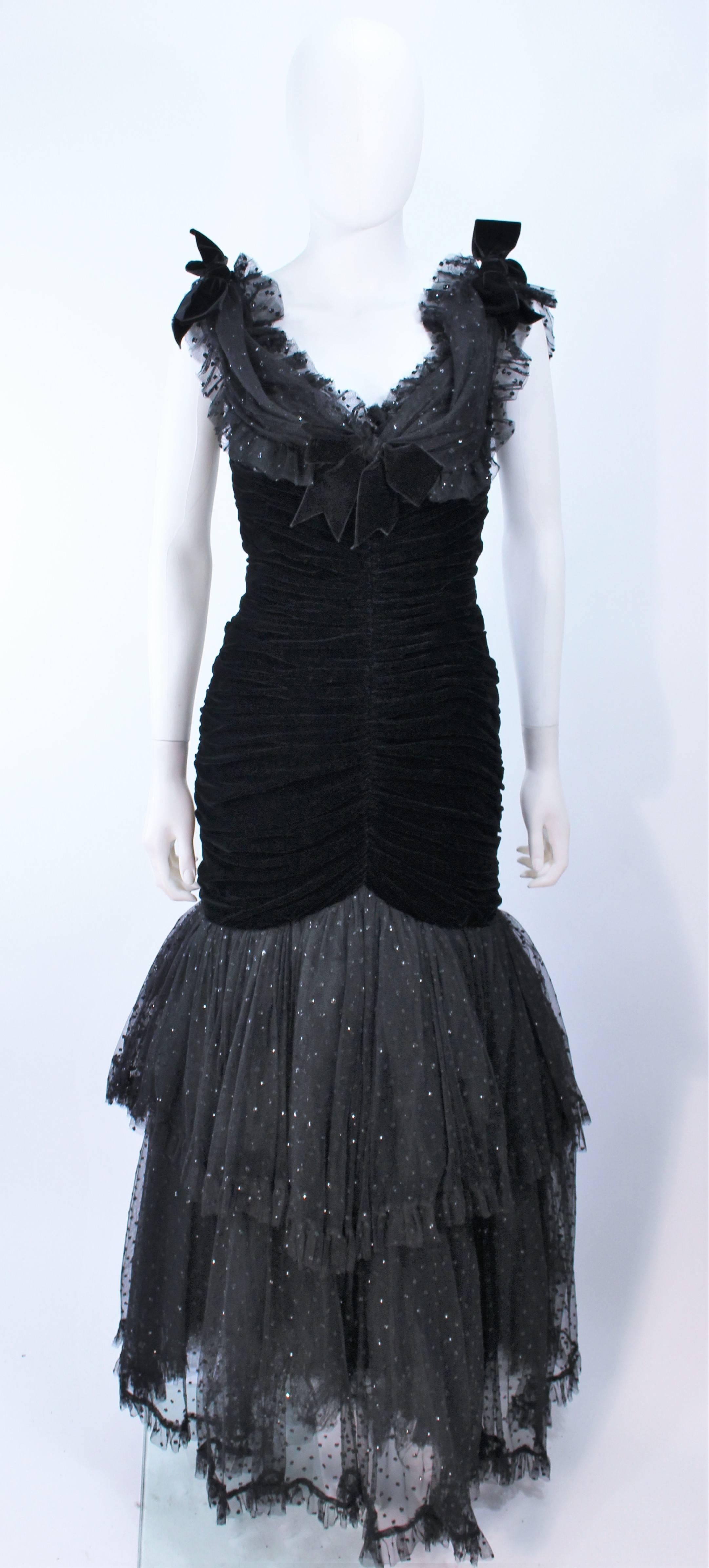 This Belville Sasson gown is composed of a black velvet with lace, and mesh accenting. Features a ruched style with center back zipper closure. Can be worn on and off the shoulders. Boned interior. In excellent vintage condition.

**Please