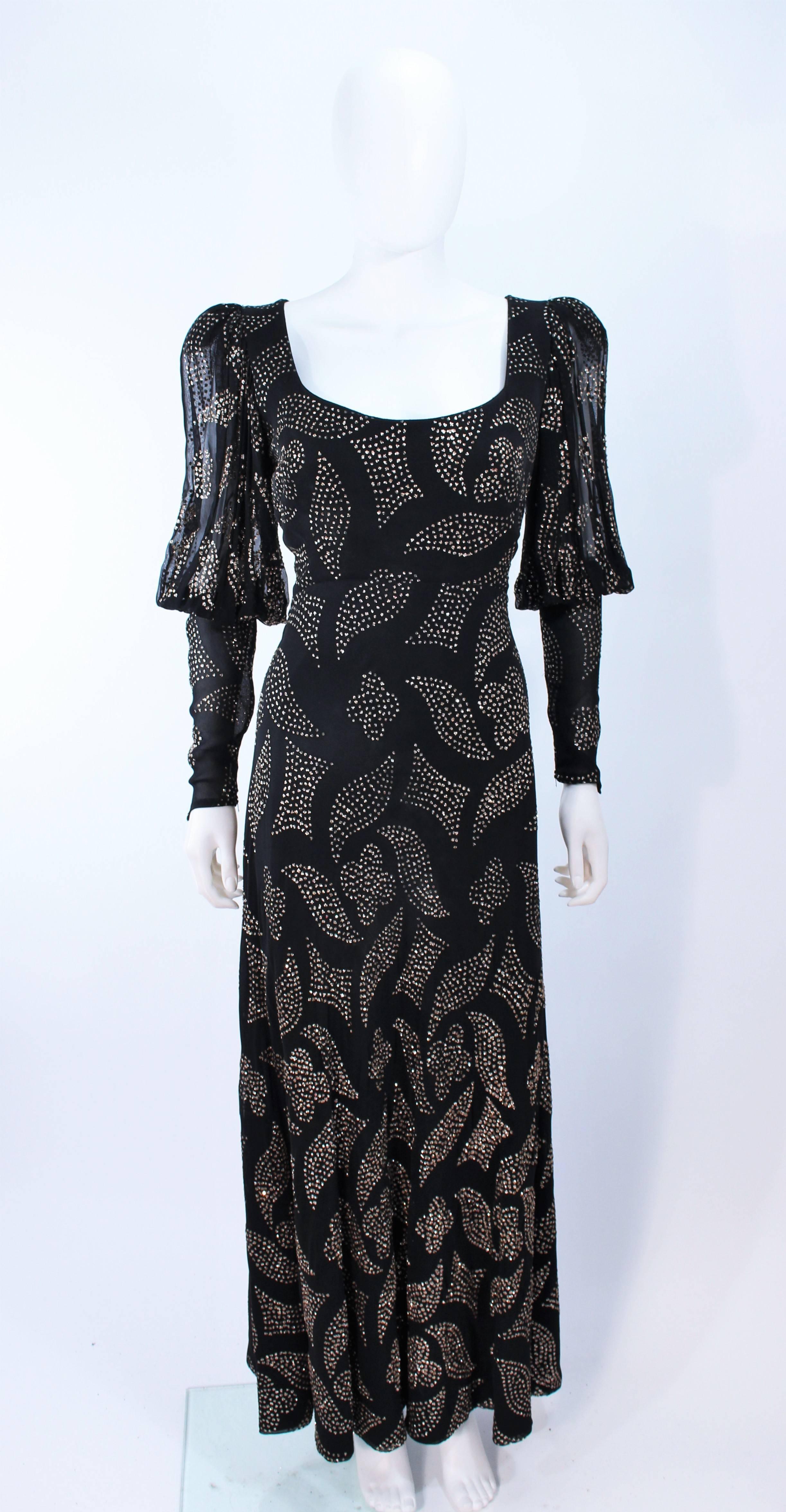 This Pauline Trigere gown is composed of a crepe silk with patterned sequin applique. Features full sheer sleeves and zippered cuffs. There is a center back zipper closure. In excellent vintage condition, there is some slight discoloration due to