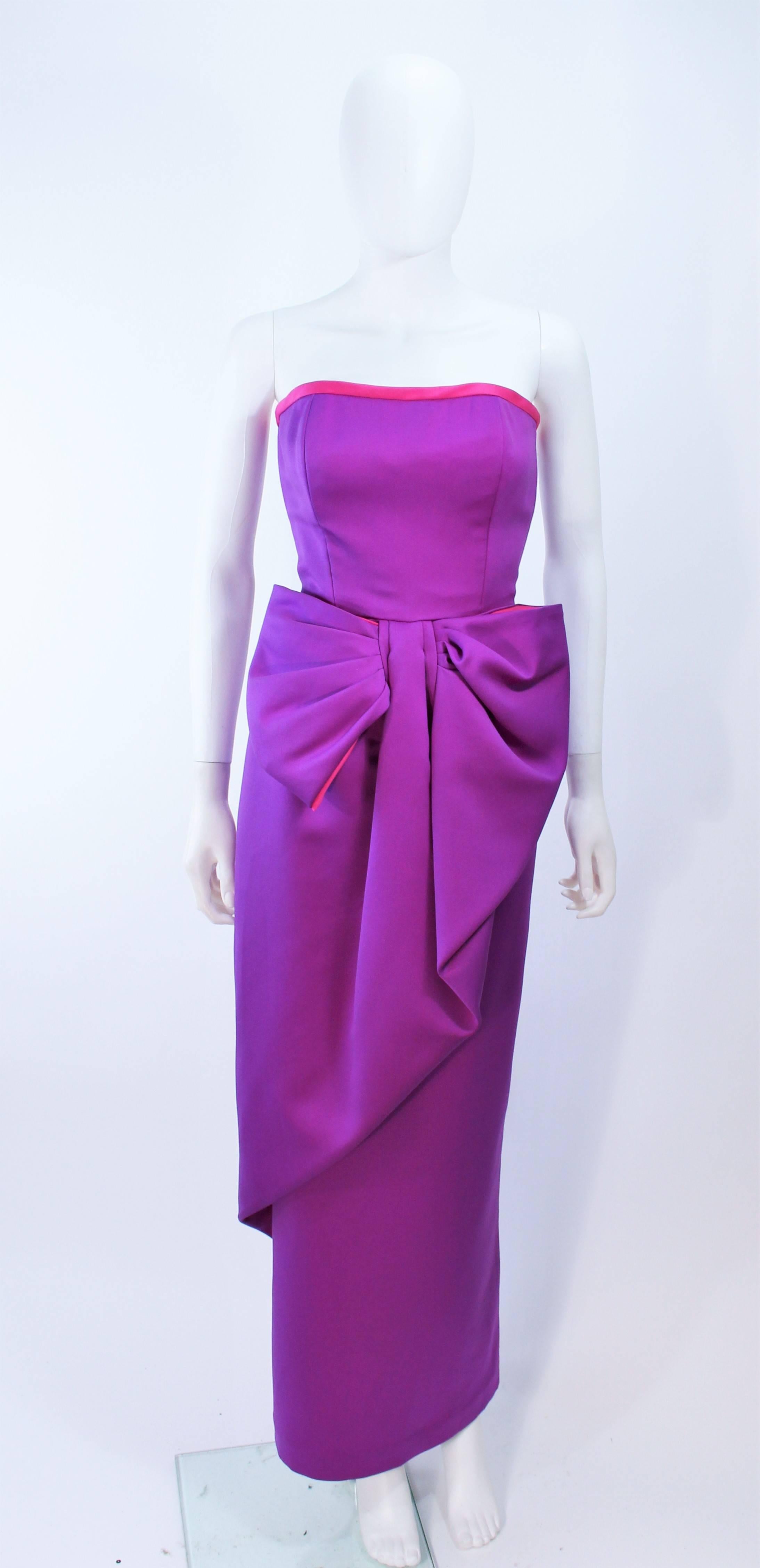 This Victor Costa gown is composed of a purple and magenta combination. Features a front draped bow at the waist. There is a center back zipper closure. In excellent vintage condition.

**Please cross-reference measurements for personal accuracy.