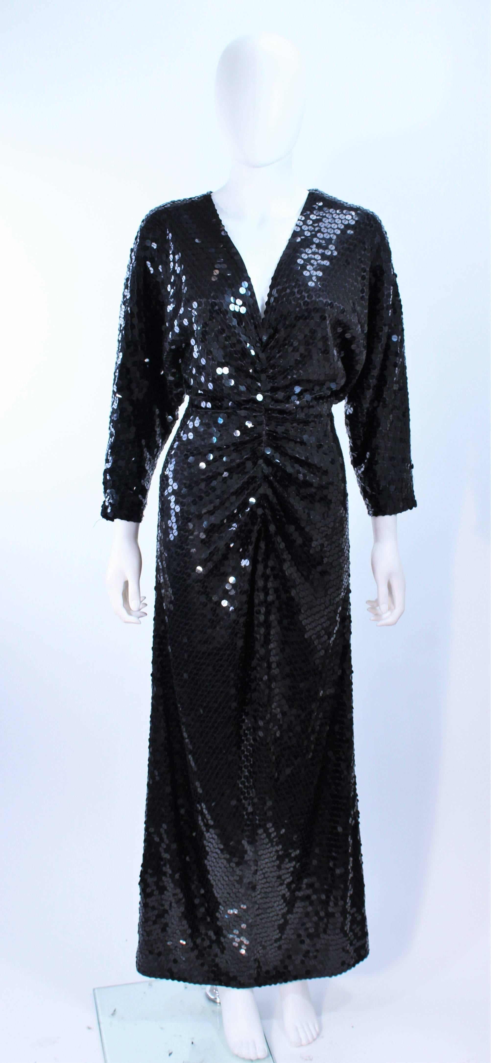 This Oleg Cassini is composed of a sequined black jersey. Features a draped front with center back zipper closure. In excellent vintage condition.

**Please cross-reference measurements for personal accuracy. Size in description box is an