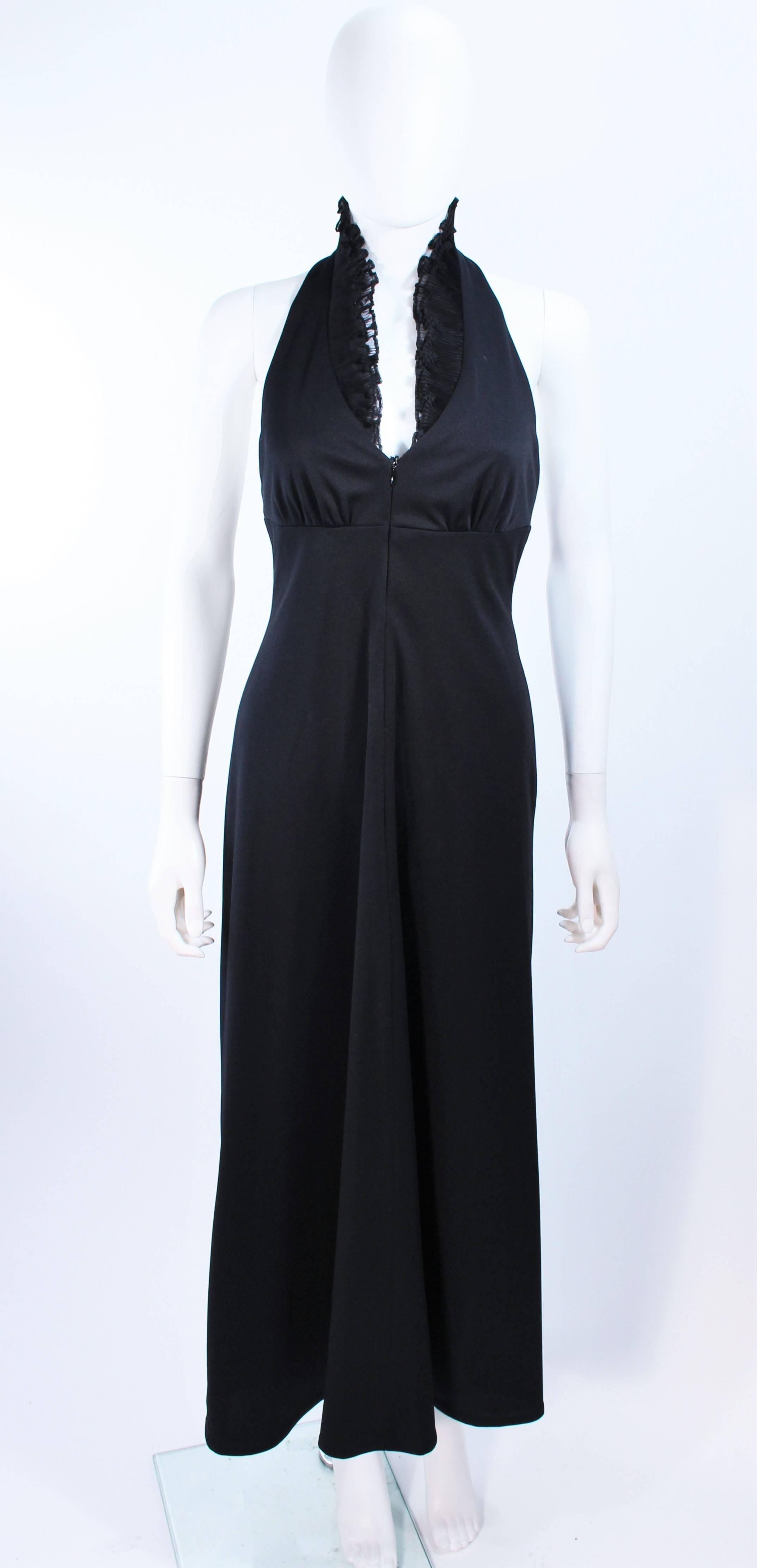 This gown is composed of a black jersey and features a ruffle neckline detail. There is a center back zipper closure. In excellent vintage condition.

**Please cross-reference measurements for personal accuracy. Size in description box is an