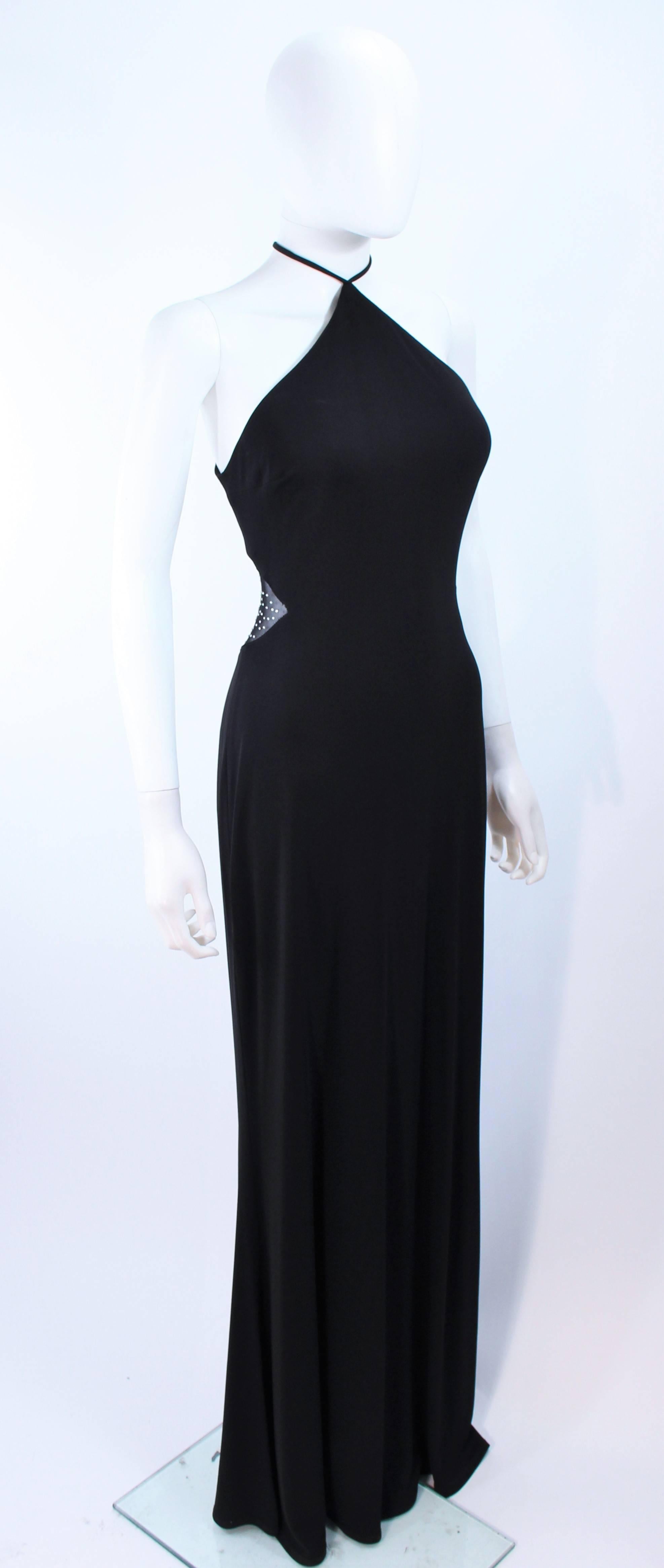This Nicole Barti gown is composed of a black jersey. Features a sheer mesh back with rhinestone applique. In excellent vintage condition.

**Please cross-reference measurements for personal accuracy. 

Measures (Approximately)
Length:
