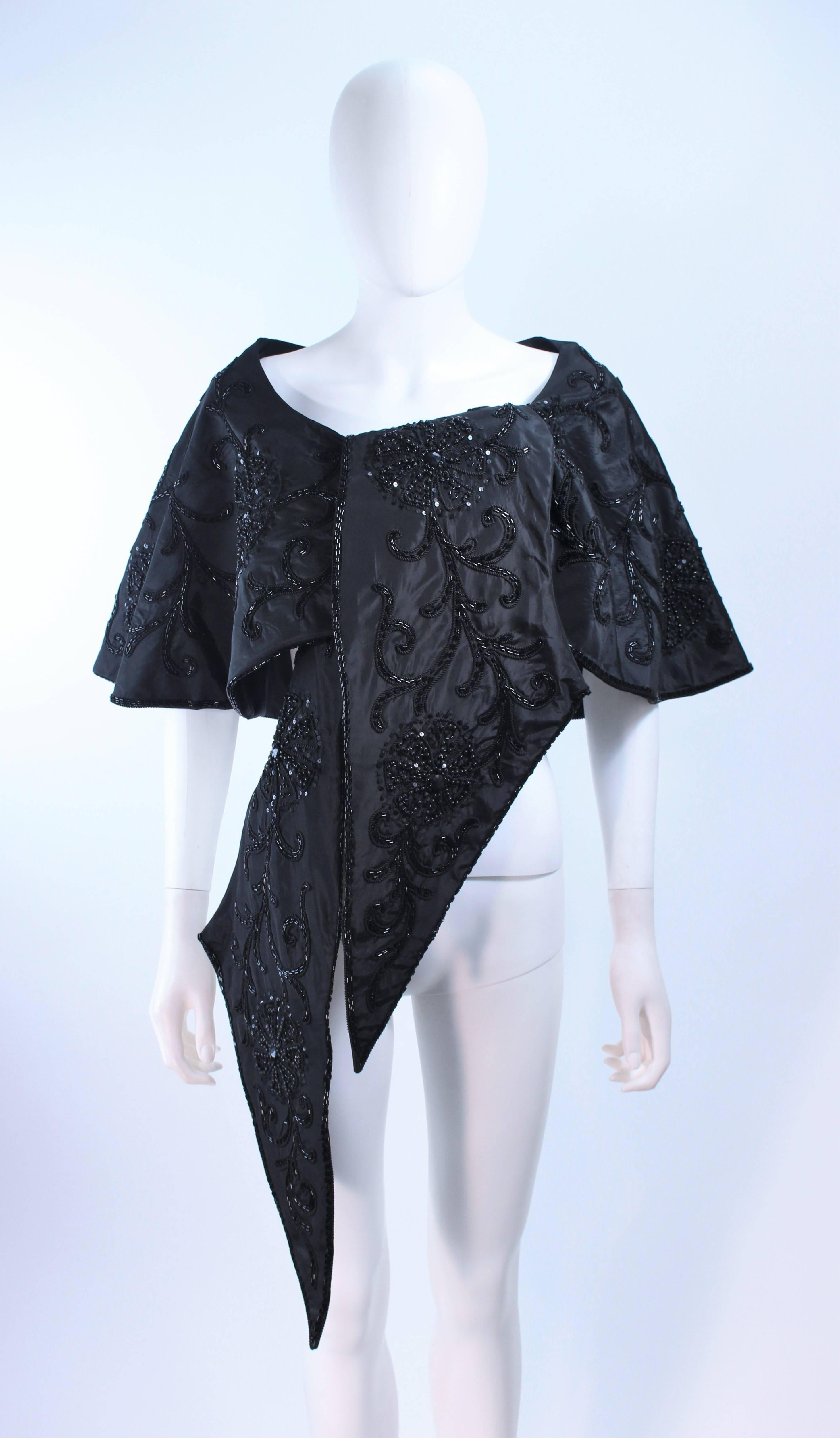 This wrap is composed of a black hand beaded silk. This versatile wrap can be worn in a variety of fashions. In excellent vintage condition.

**Please cross-reference measurements for personal accuracy. 

Measures (Approximately)
Length: