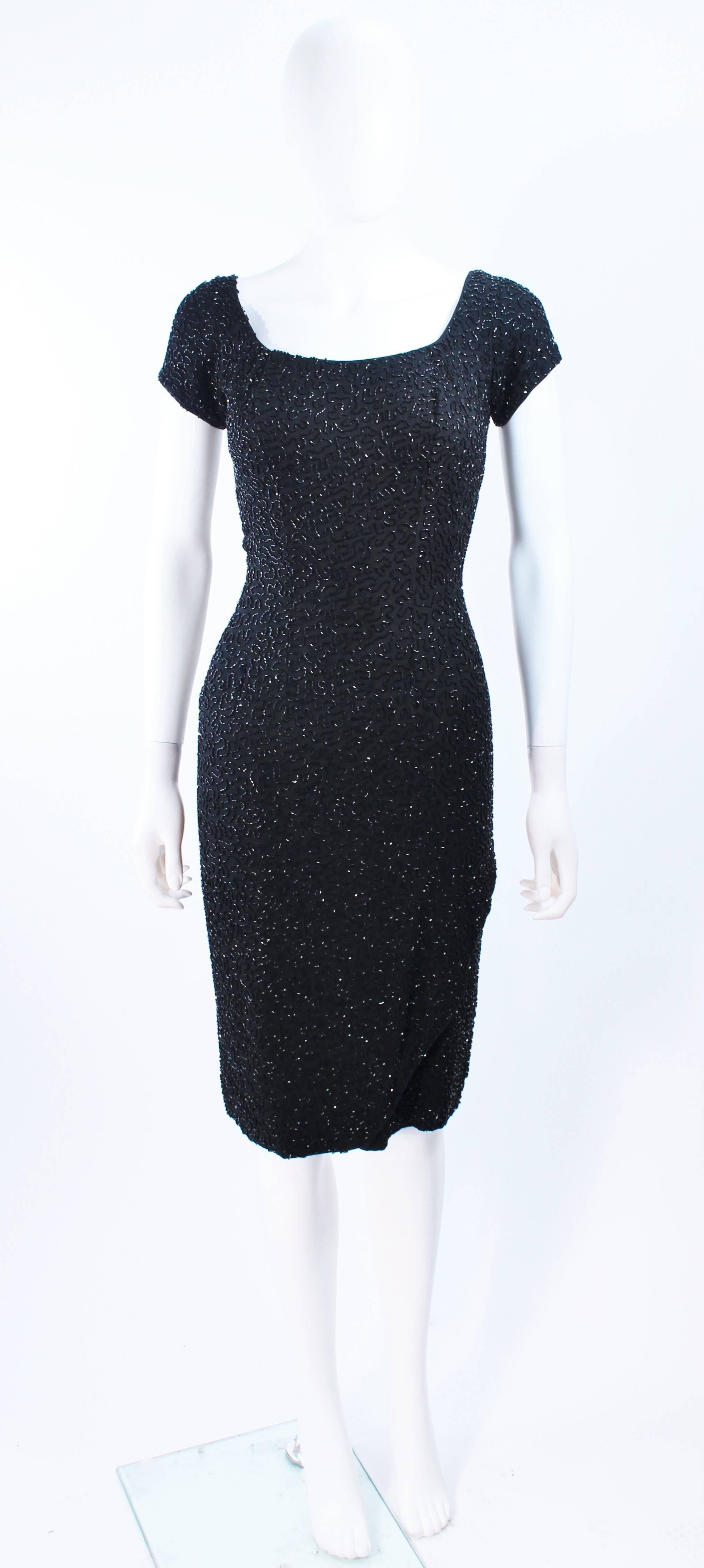 This Ceil Chapman cocktail dress is composed of a hand beaded black silk. Features a center back draped style and a zipper closure. In excellent vintage condition.

**Please cross-reference measurements for personal accuracy. Size in description