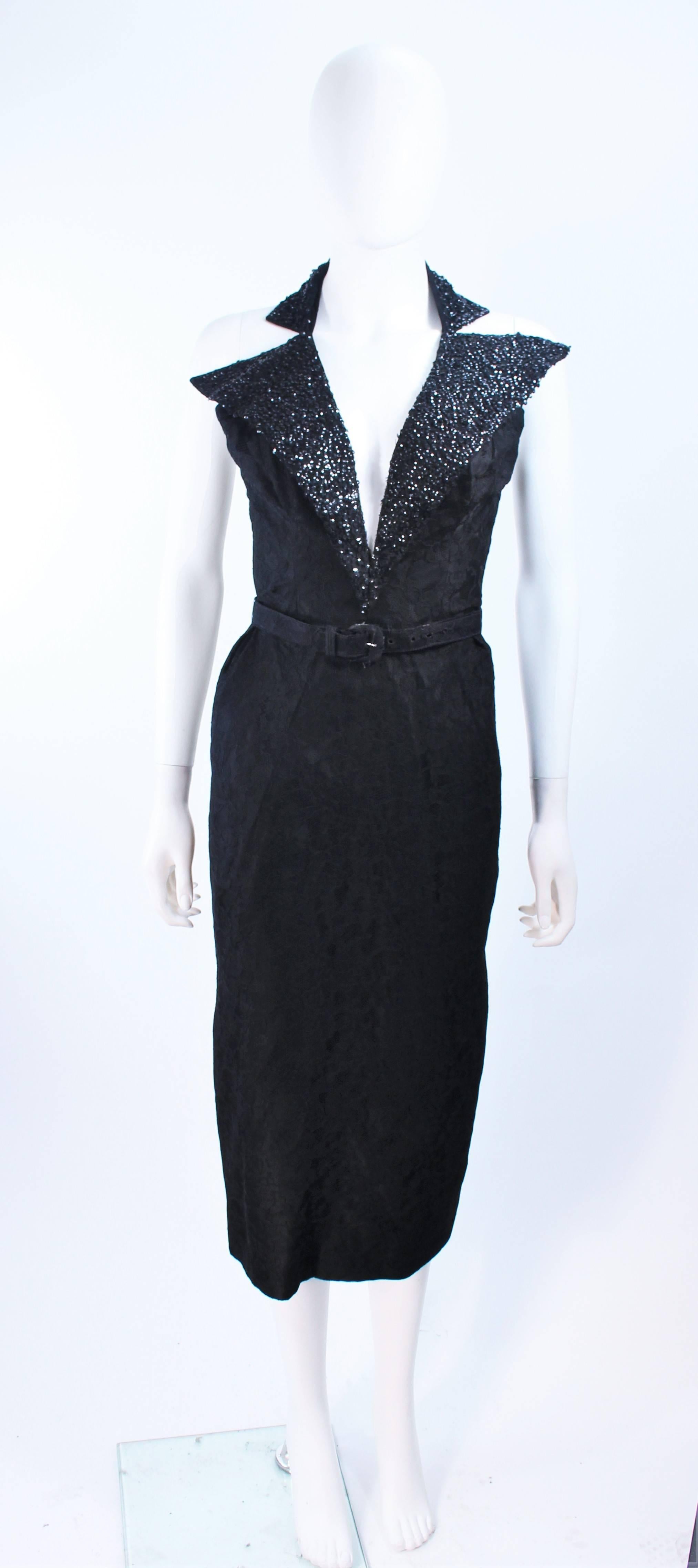 This design by Kenneth Johnson is composed of a black lace with a sequin collar. Features a waist belt and center back zipper closure. In excellent vintage condition.

**Please cross-reference measurements for personal accuracy. Size in