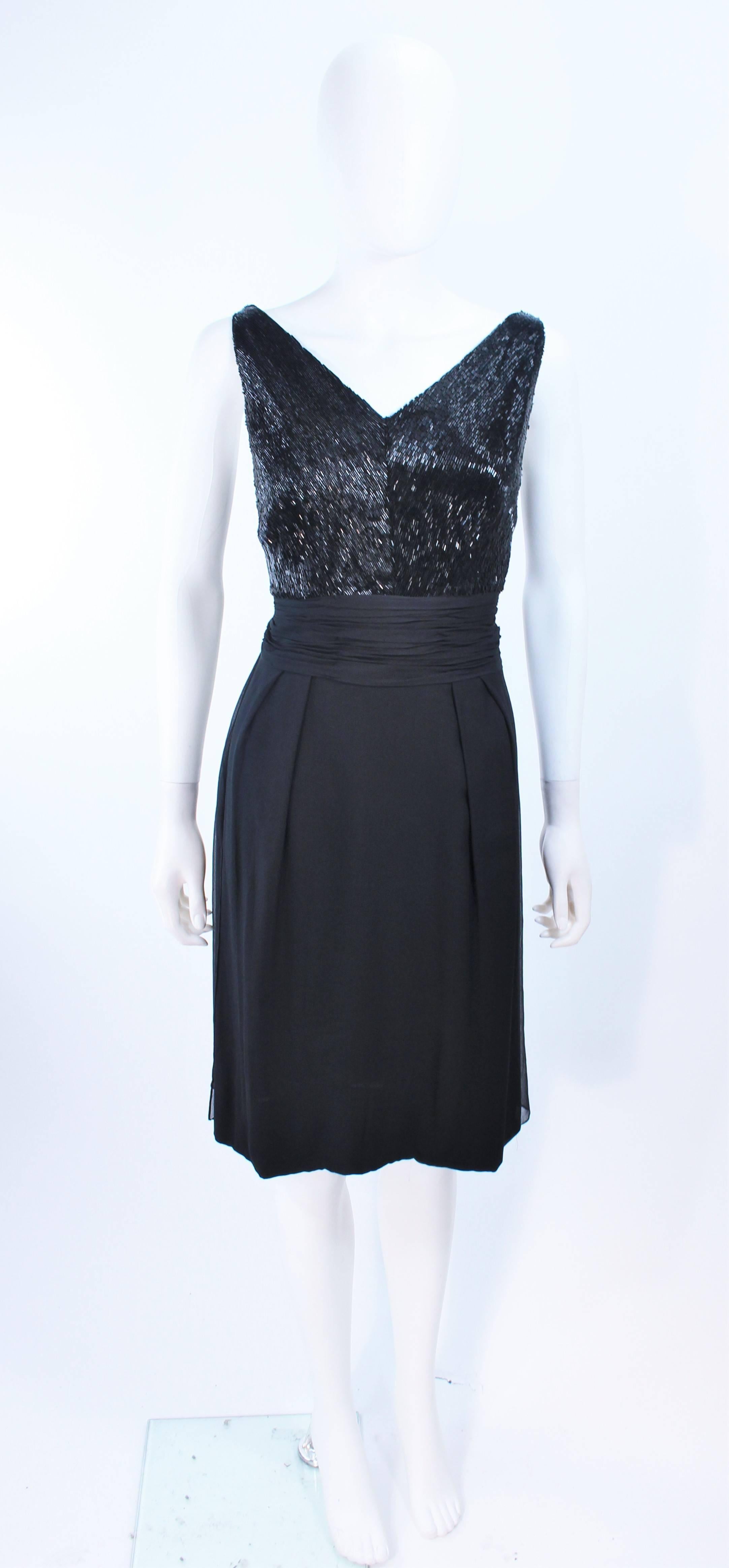 This cocktail dress is composed of a black silk chiffon. Features a beaded bust detail with gathered waist. There is a center back zipper closure. In excellent vintage condition.

**Please cross-reference measurements for personal accuracy. Size