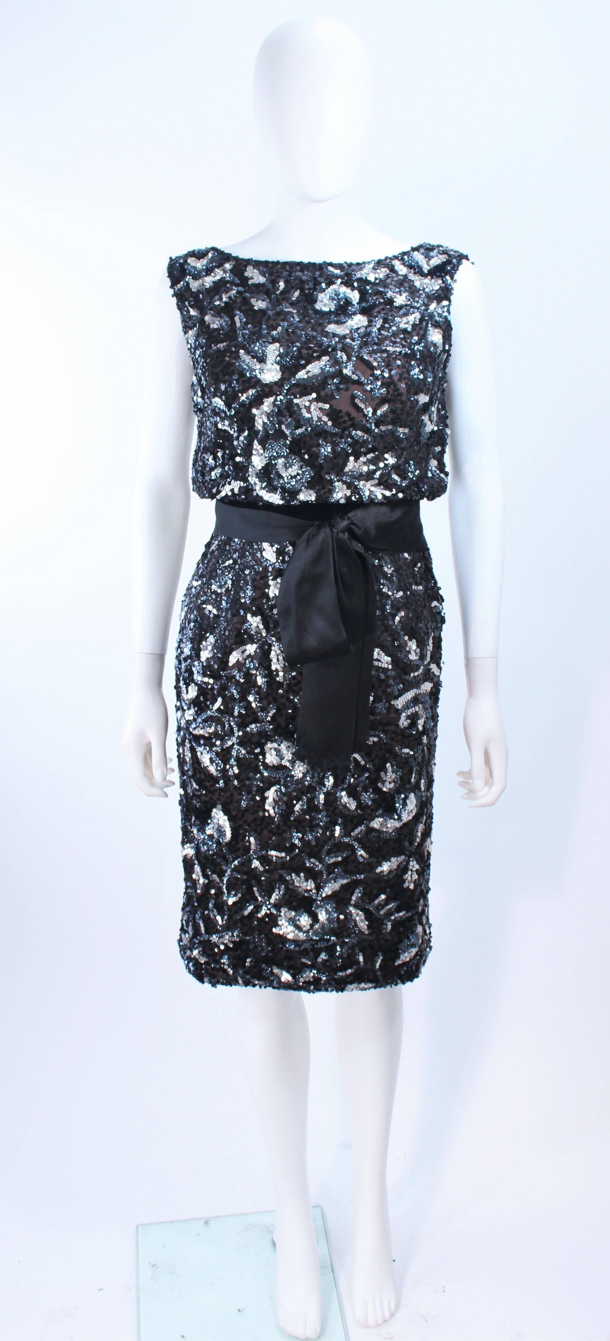 This vintage cocktail dress is composed of a silk chiffon with a sequin floral applique in silver and black hues. There is a side zipper closure with hook and eyes. In excellent vintage condition.

**Please cross-reference measurements for