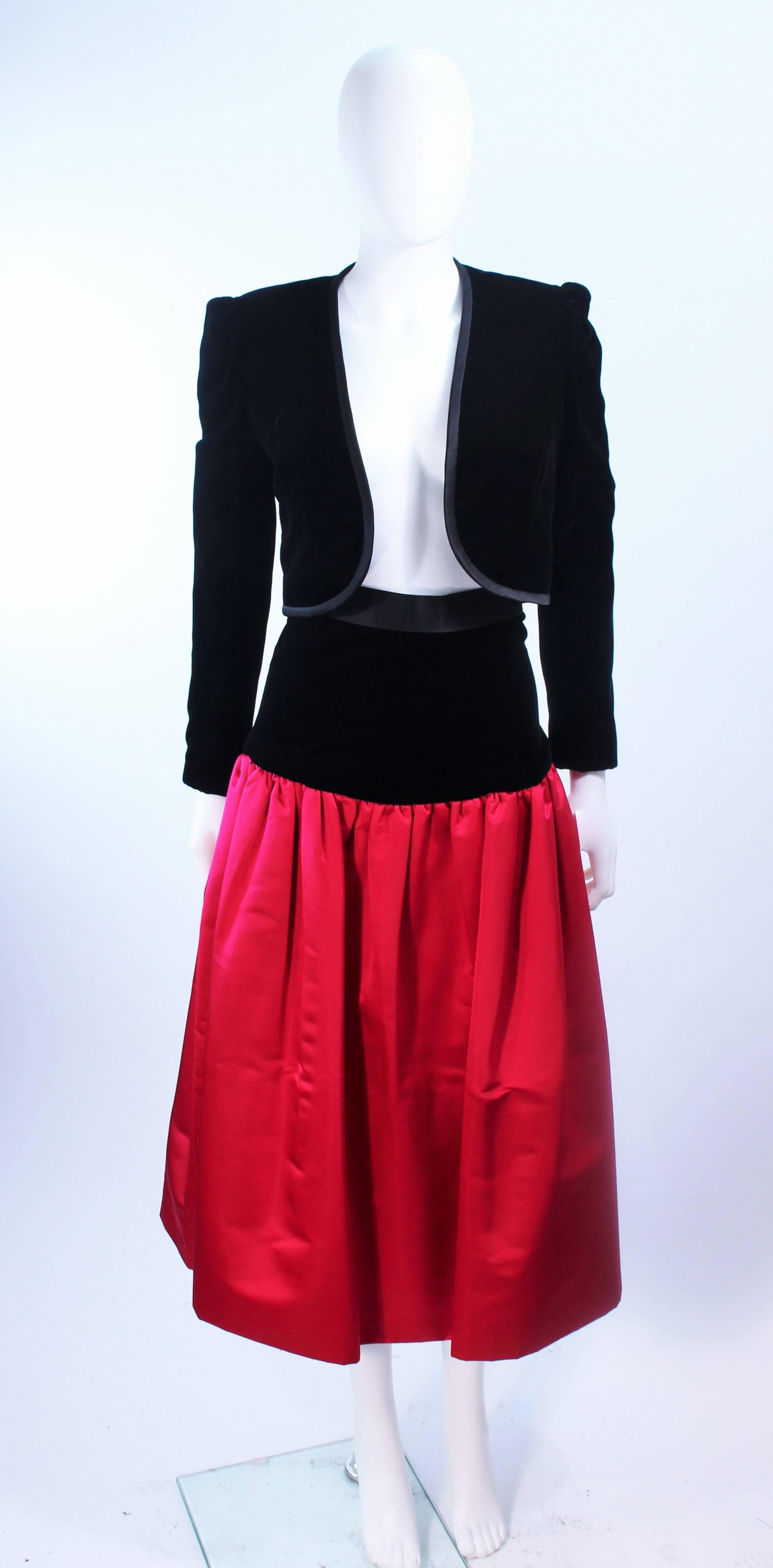 This Adolfo ensemble is composed of a wonderful silk and velvet combination, in contrasting black and red. The full skirt features a tulle interior with zipper closure. The jacket has an open bolero style. In excellent vintage condition.

**Please