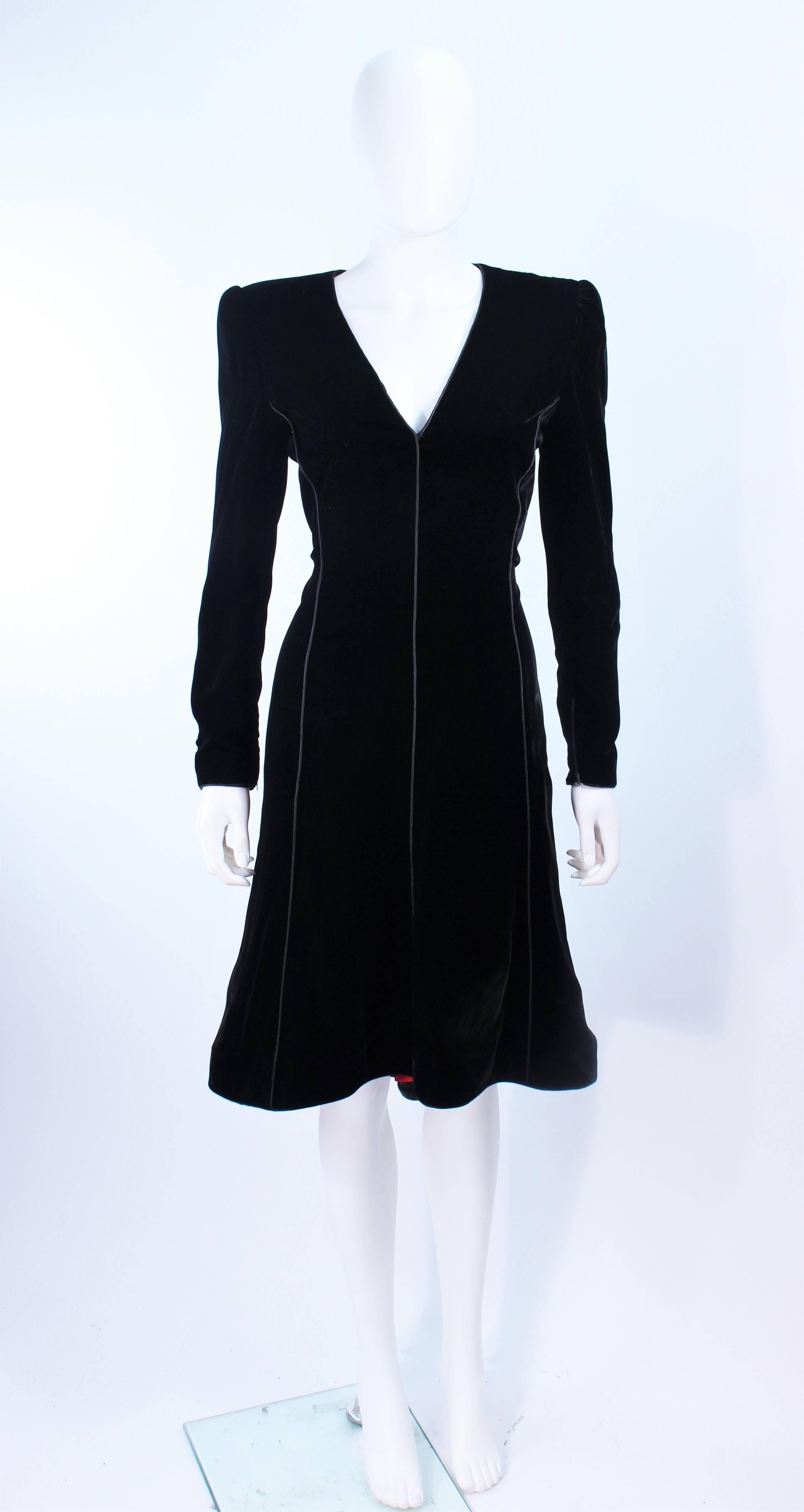 This Valentino cocktail dress is composed of black velvet and features an interior contrasting pleated detail in red. There is a center back zipper closure. In excellent vintage condition.

**Please cross-reference measurements for personal