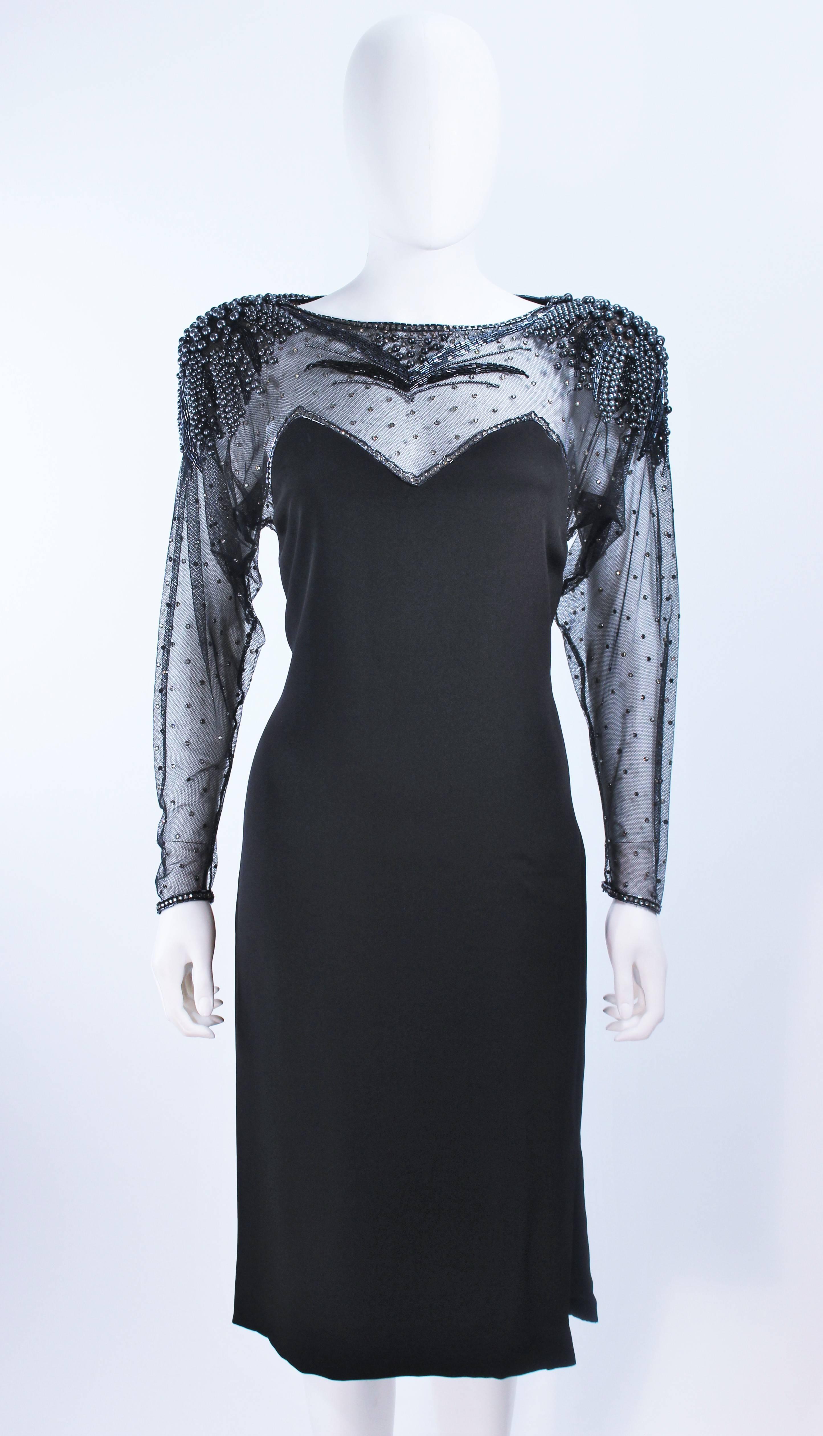 This Frank Composto cocktail dress is composed of a black silk and features sheer sleeves with beaded applique. There is a center back zipper closure. In excellent vintage condition.

**Please cross-reference measurements for personal accuracy.