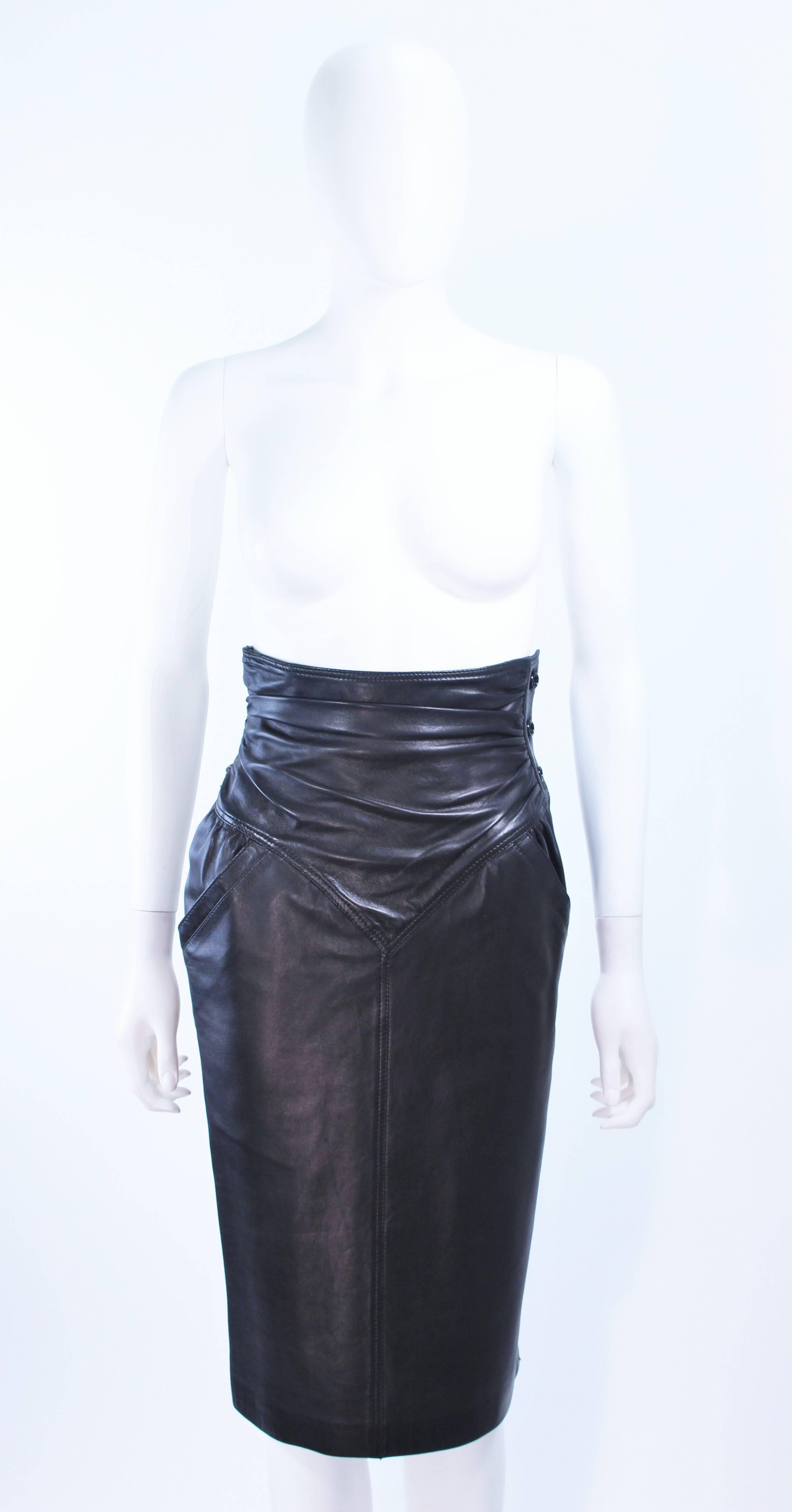This Ungaro skirt is composed of a black leather and features a high waist style. There is a side zipper closure with buttons. In excellent vintage condition.

**Please cross-reference measurements for personal accuracy. Size in description box is