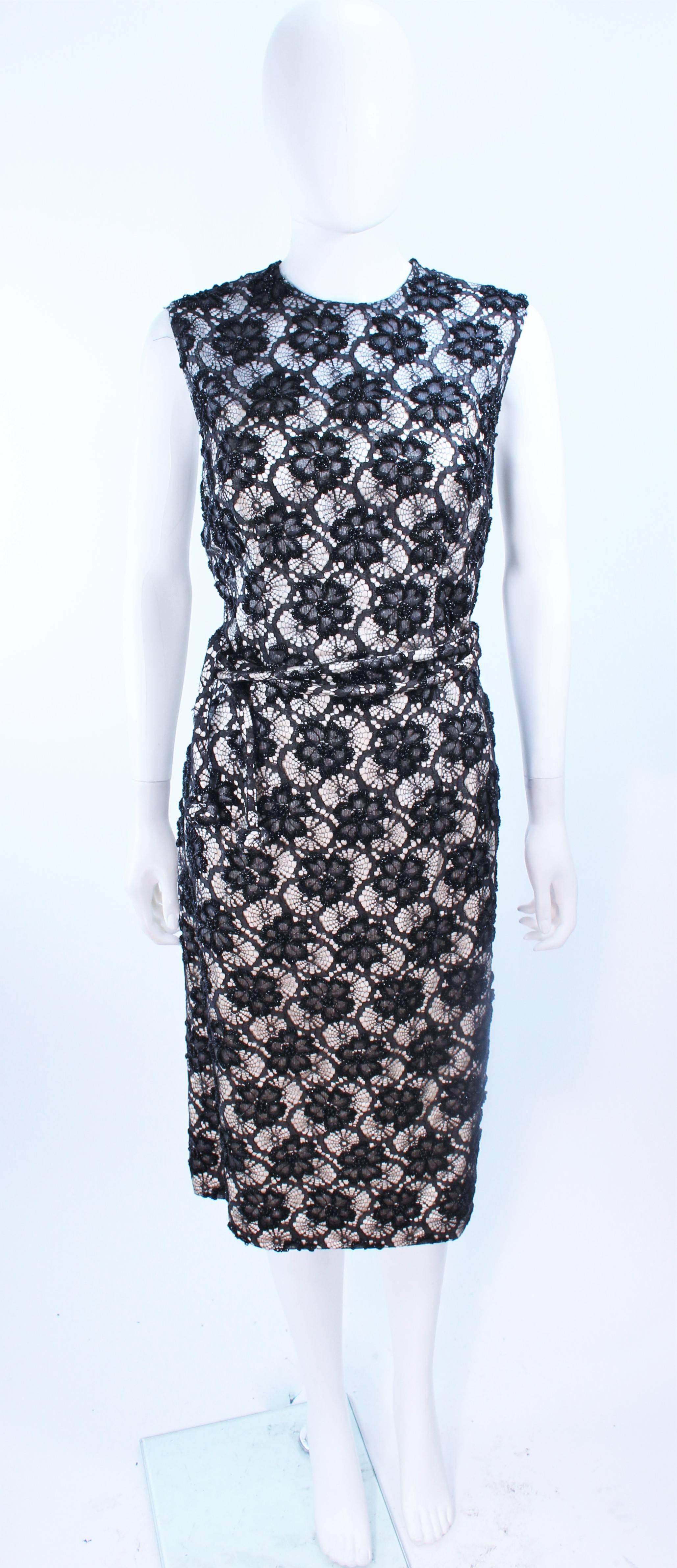 This Swee Lo for Haute Couture International dress is composed of a black and white beaded silk. Features a floral pattern with belt. There is a center back zipper closure. In excellent vintage condition, with original tags.

**Please