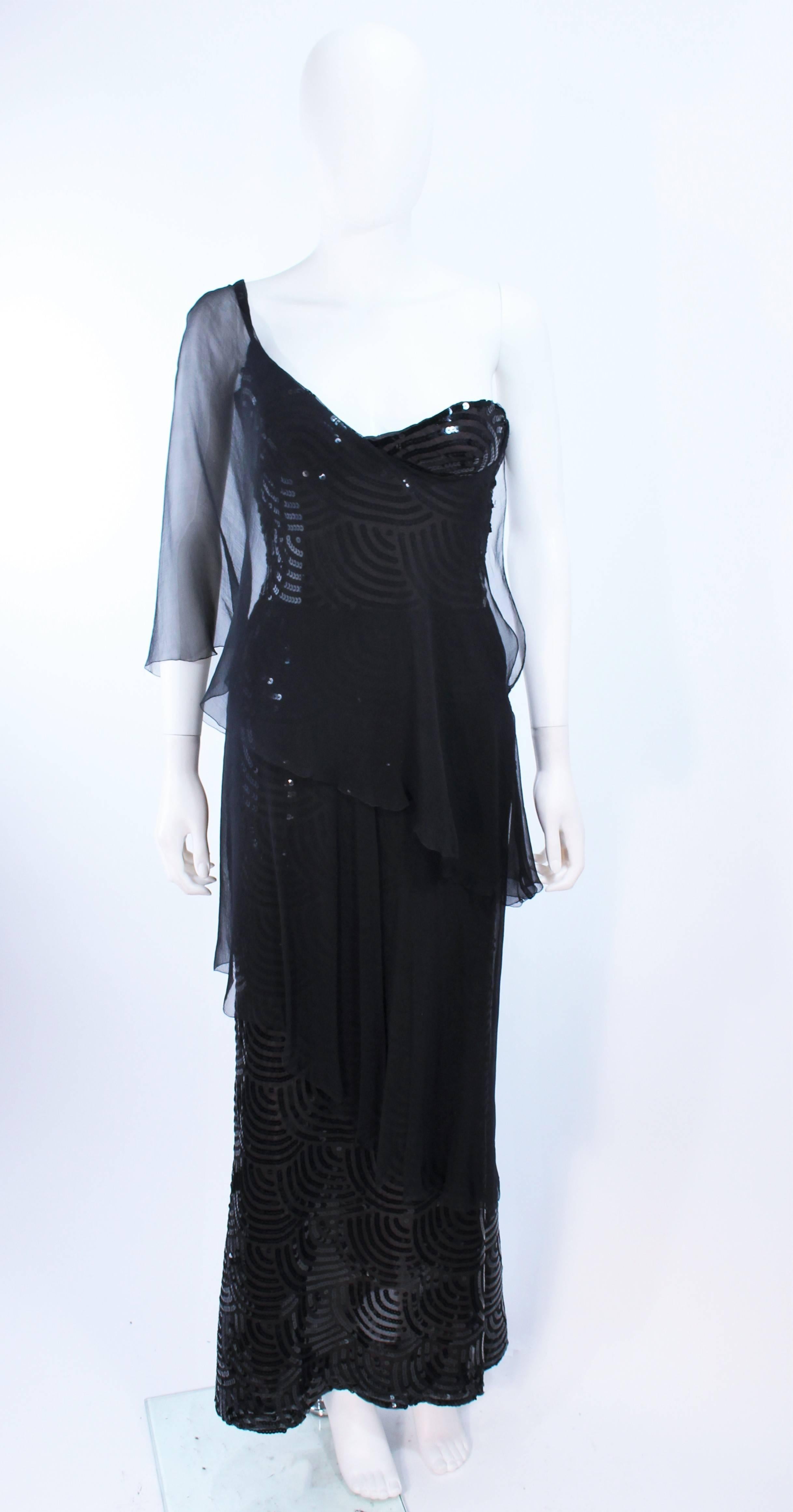 This Loris Azzaro attributed gown is composed of black silk chiffon with sequin applique throughout. Features a draped one shoulder style. There is a side zipper closure, with hook & eyes, with interior bustier as well. In excellent vintage