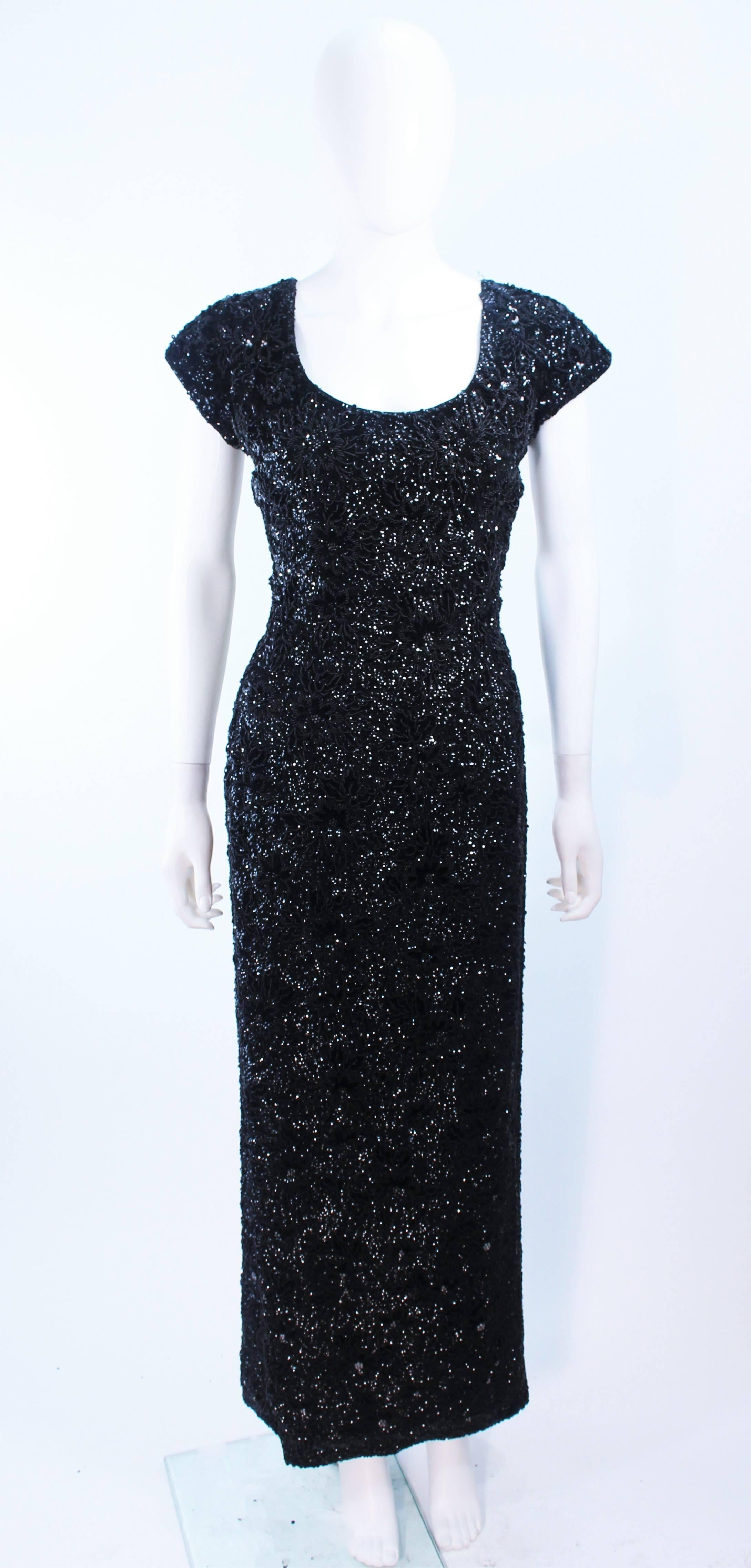 This Super Sexy Bruce Arnold gown is fully hand-beaded and composed of a black sequin on rayon and features a floral detail. There is a center back metal zipper closure. The gown is in excellent condition and truly is a show-stopper.

**Please