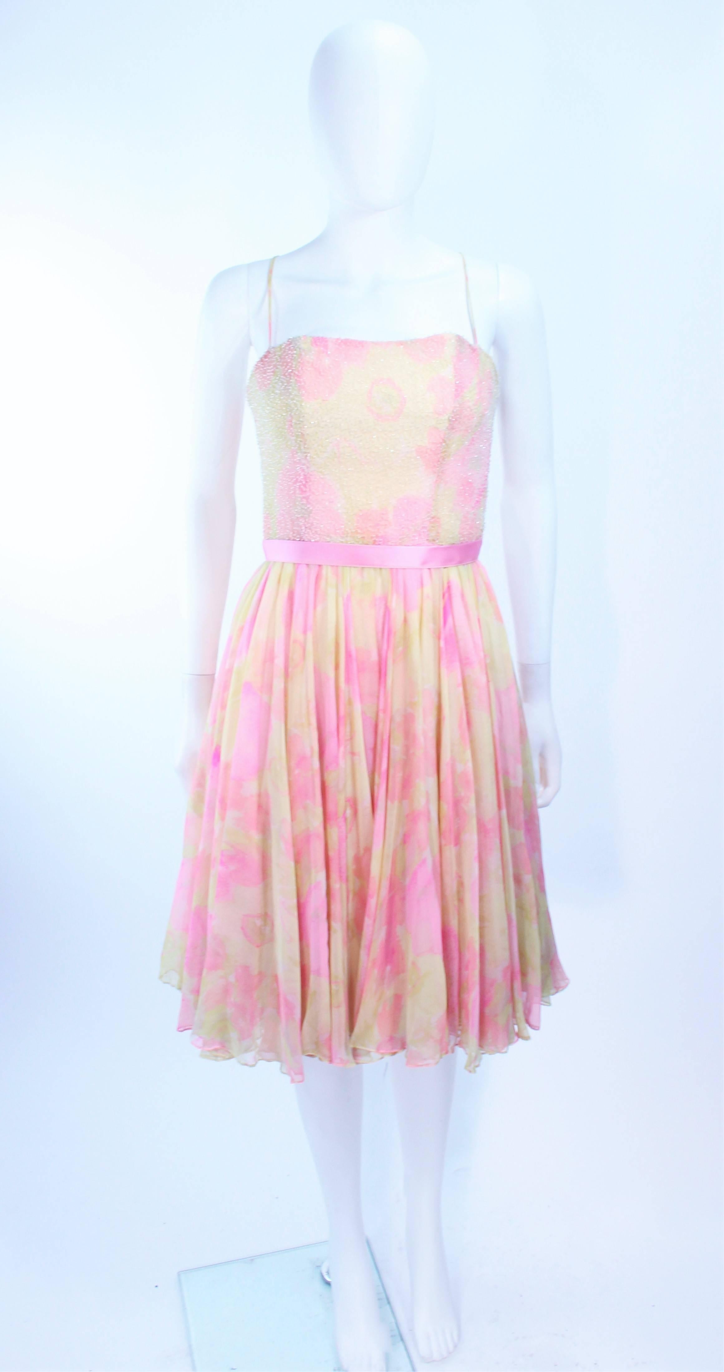 This Mildred cocktail dress is composed of a pink and yellow chiffon with floral pattern. Features a beaded bodice. There is a center back zipper closure, with satin belt. In excellent vintage condition.

**Please cross-reference measurements for