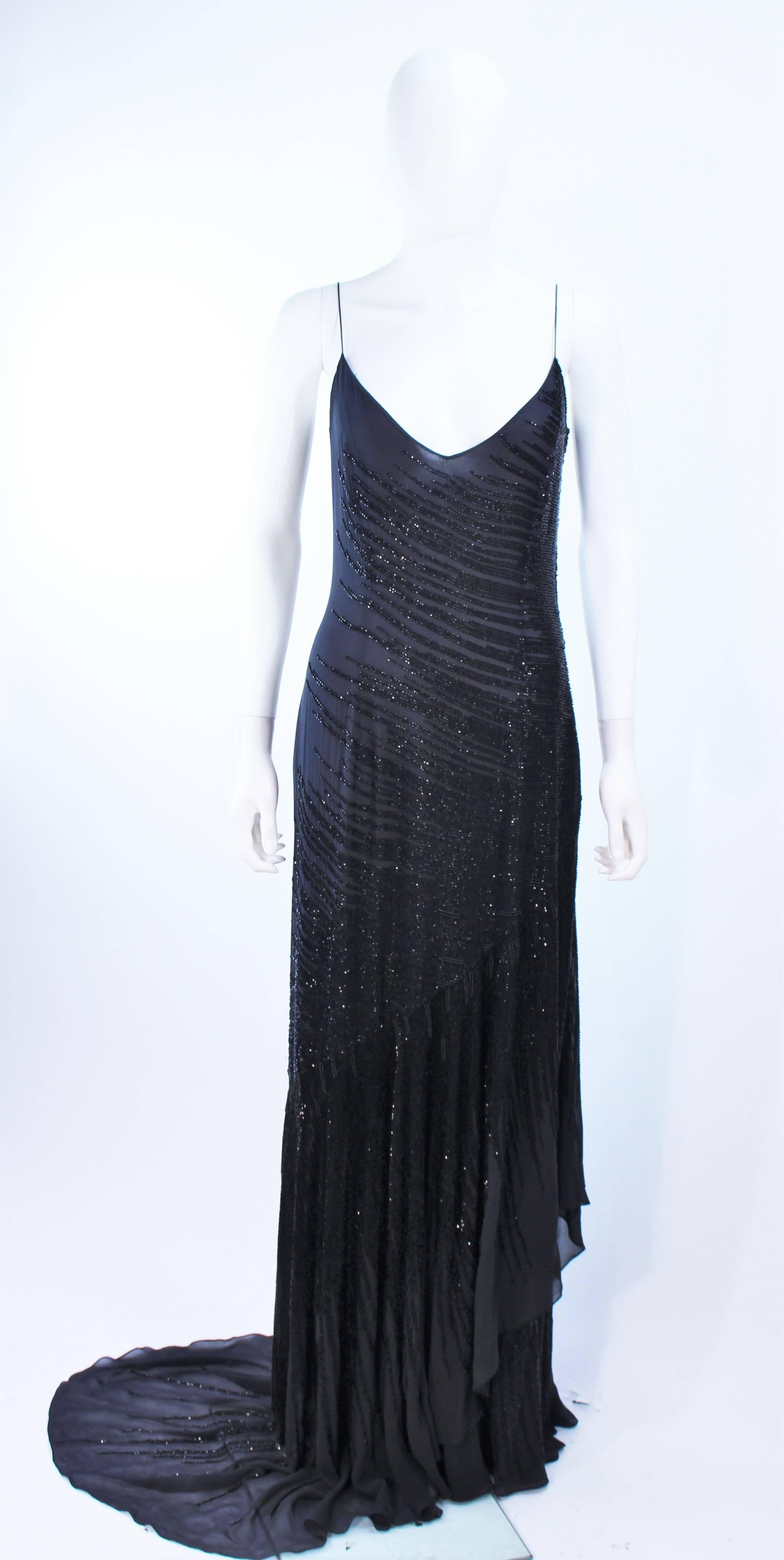 This Amanda Wakely gown is composed of a beaded black silk chiffon. Features a side draped train and cascading layers of chiffon. There is a side back zipper closure. In excellent vintage condition.

**Please cross-reference measurements for