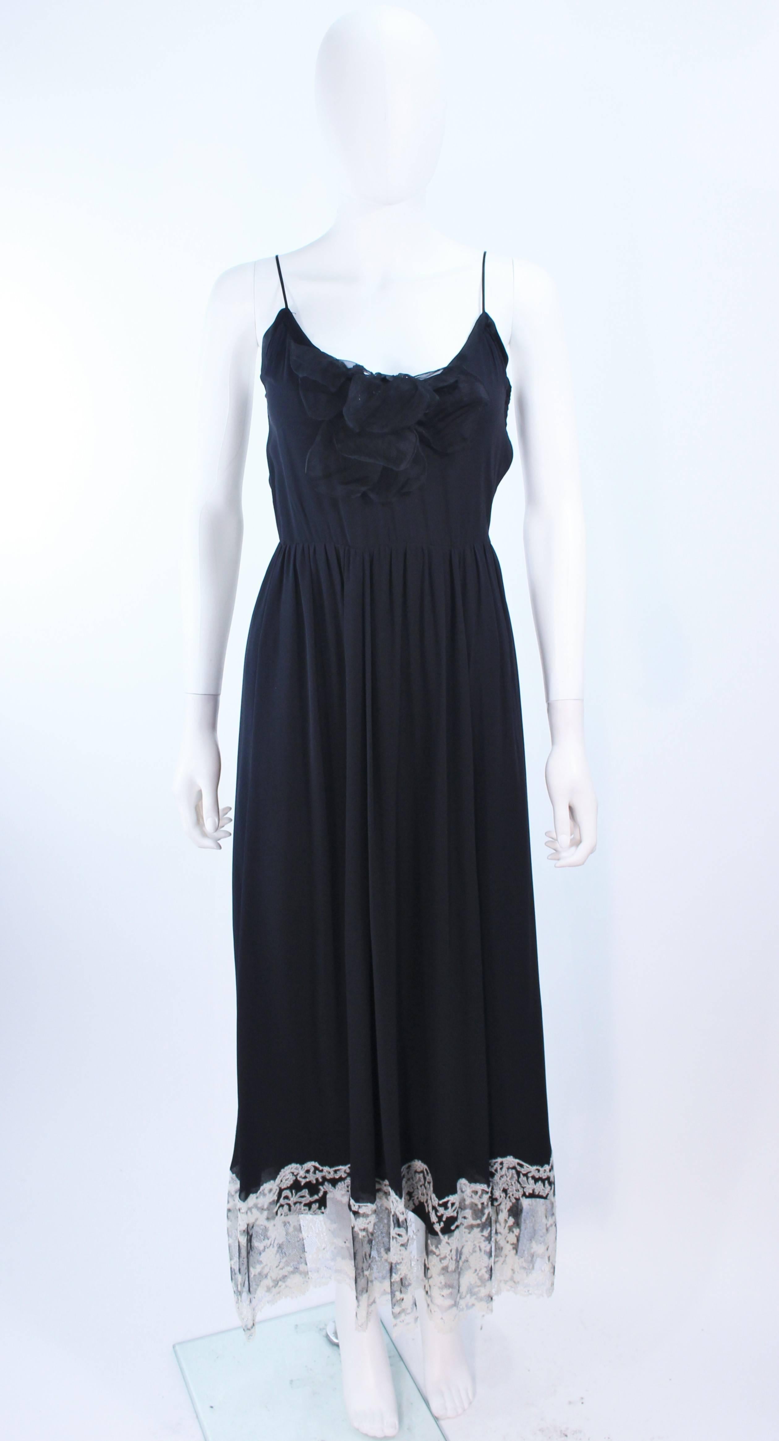 This Maggy Reeves cocktail dress is composed of a black silk chiffon. Features a center front floral applique and lace trim. There is a side zipper closure. In excellent vintage condition.

**Please cross-reference measurements for personal
