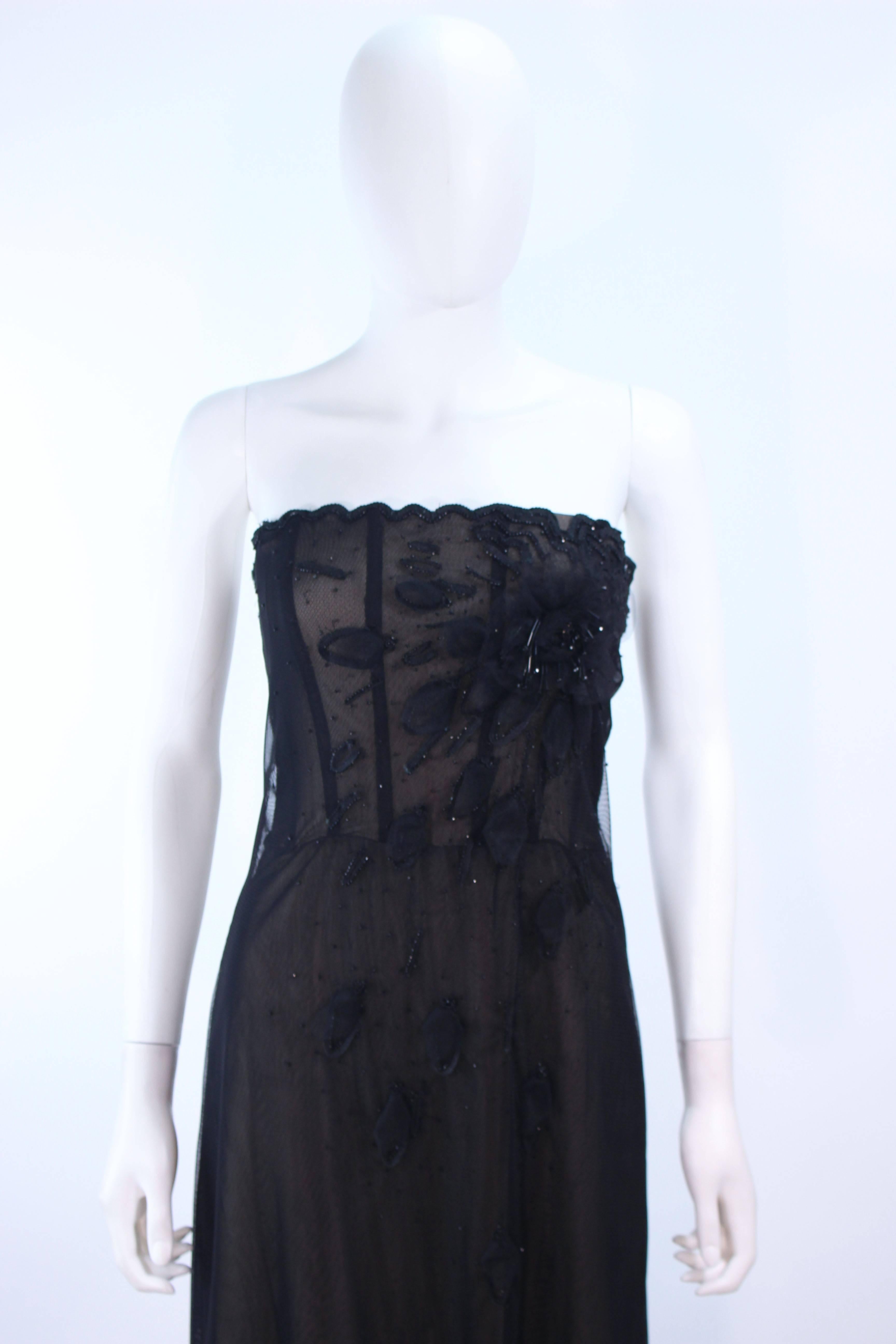 This gown is composed of a beaded black mesh with a floral pattern, and nude lining detail. Features interior boning. There is a center back zipper closure. In great vintage condition.

**Please cross-reference measurements for personal accuracy.