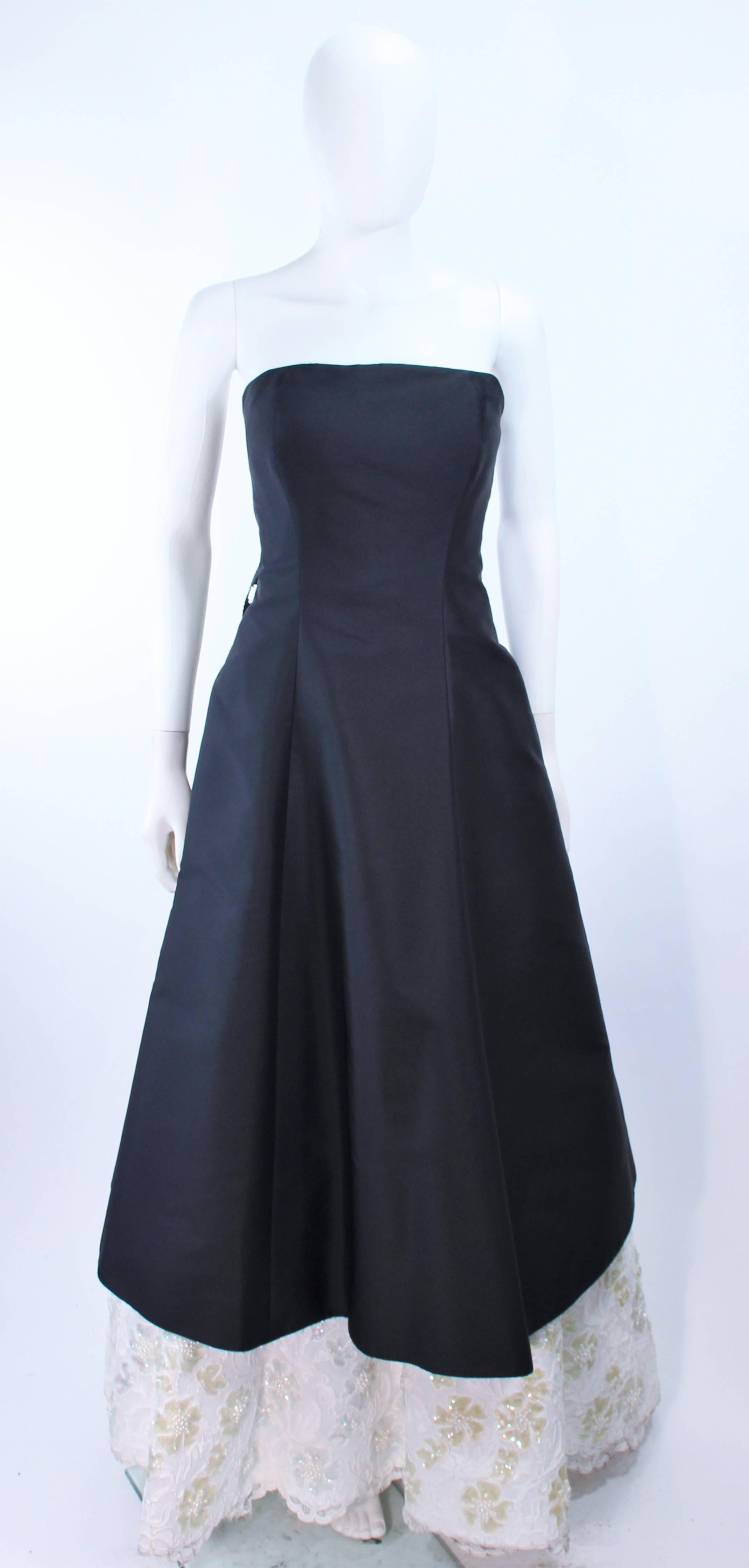 This Sam Carlin gown is composed of a black silk with a white sequin lace accenting. Features a center back bow with cascading. There is a center back zipper closure. In excellent vintage condition.

**Please cross-reference measurements for