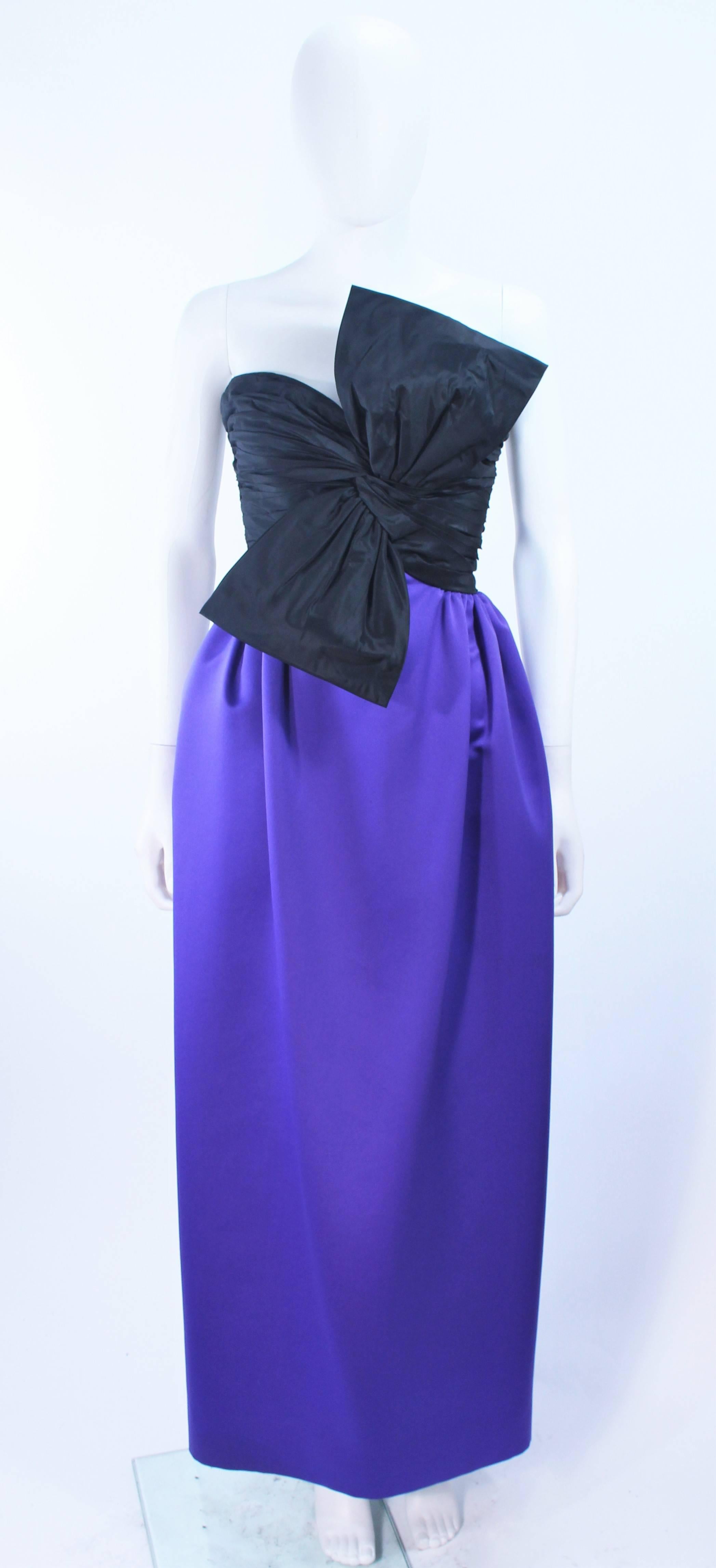 This Jill Richards gown is composed of a satin in black and purple. Features a front draped bow with a draped style skirt. There is a center back zipper closure. In excellent vintage condition. 

**Please cross-reference measurements for personal