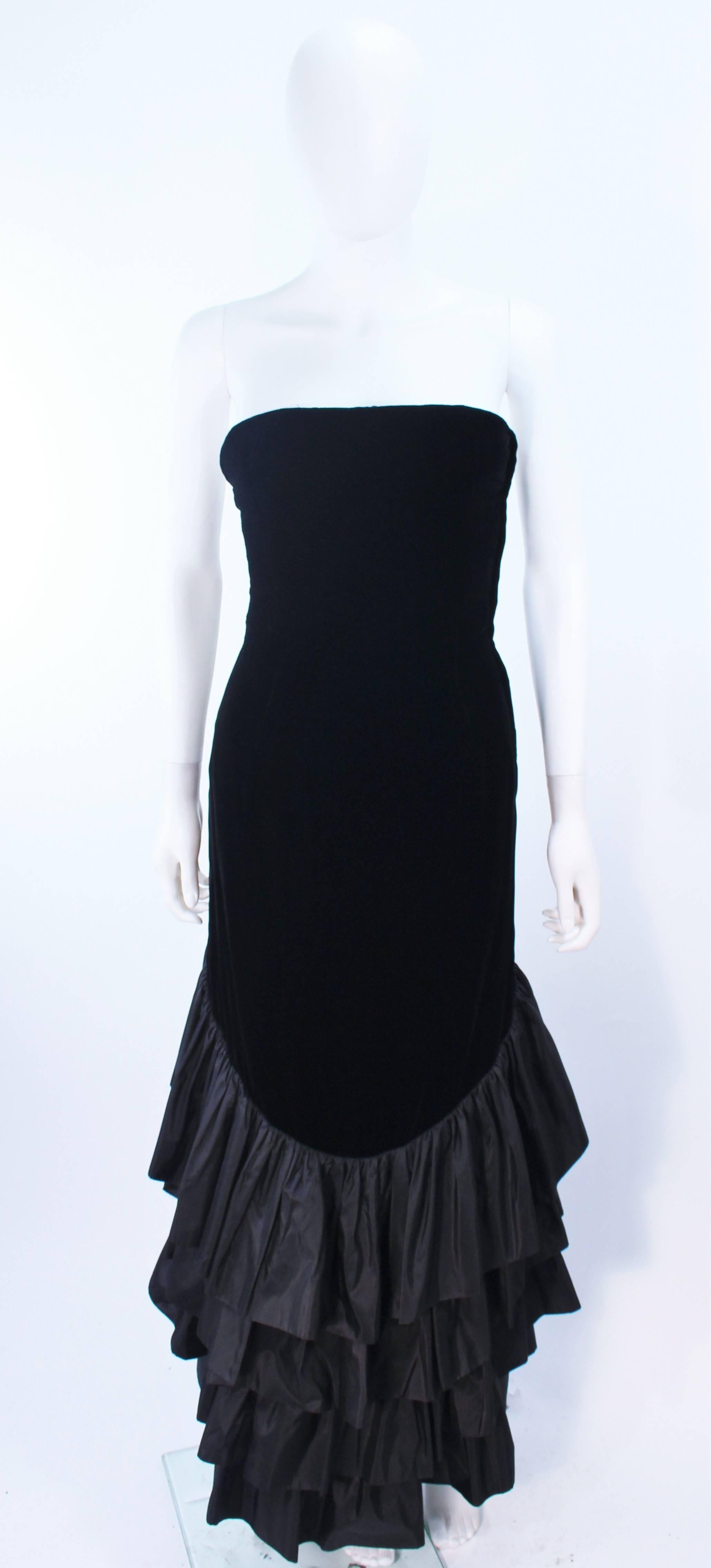 This Vicky Tiel gown is composed of black velvet and satin ruffle detailing. There is a center back zipper closure. In excellent vintage condition.

**Please cross-reference measurements for personal accuracy. Size in description box is an