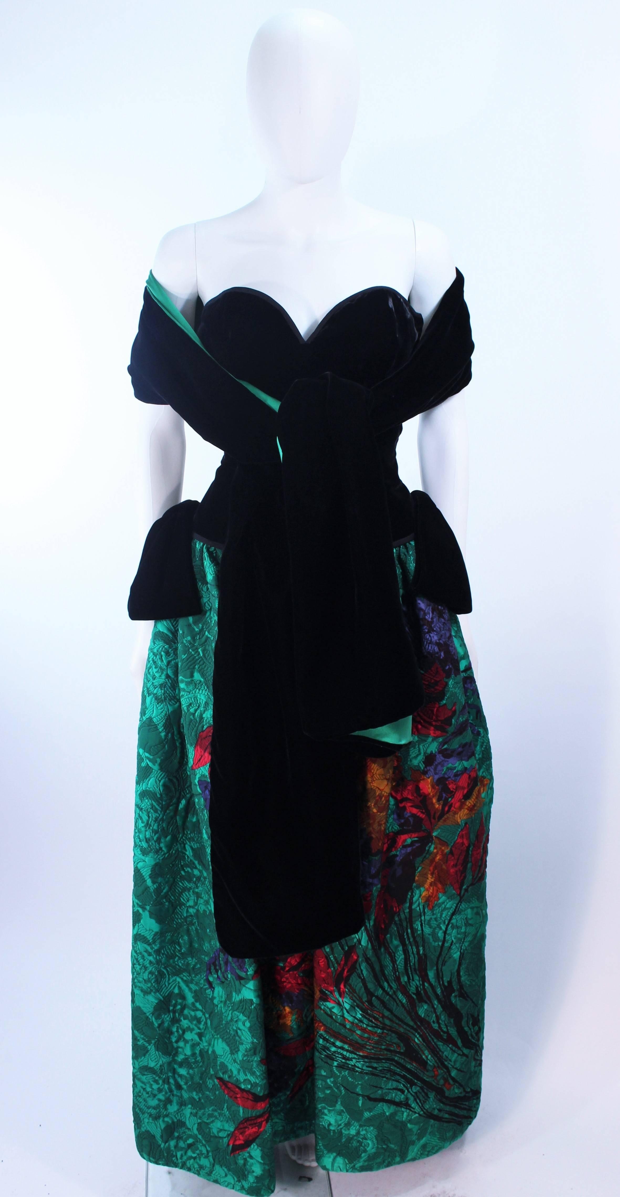 This Odicini Couture gown is composed of a black velvet bodice and green floral skirt. Comes with reversible velvet and silk wrap. There is a center back zipper closure. In excellent vintage condition.

**Please cross-reference measurements for