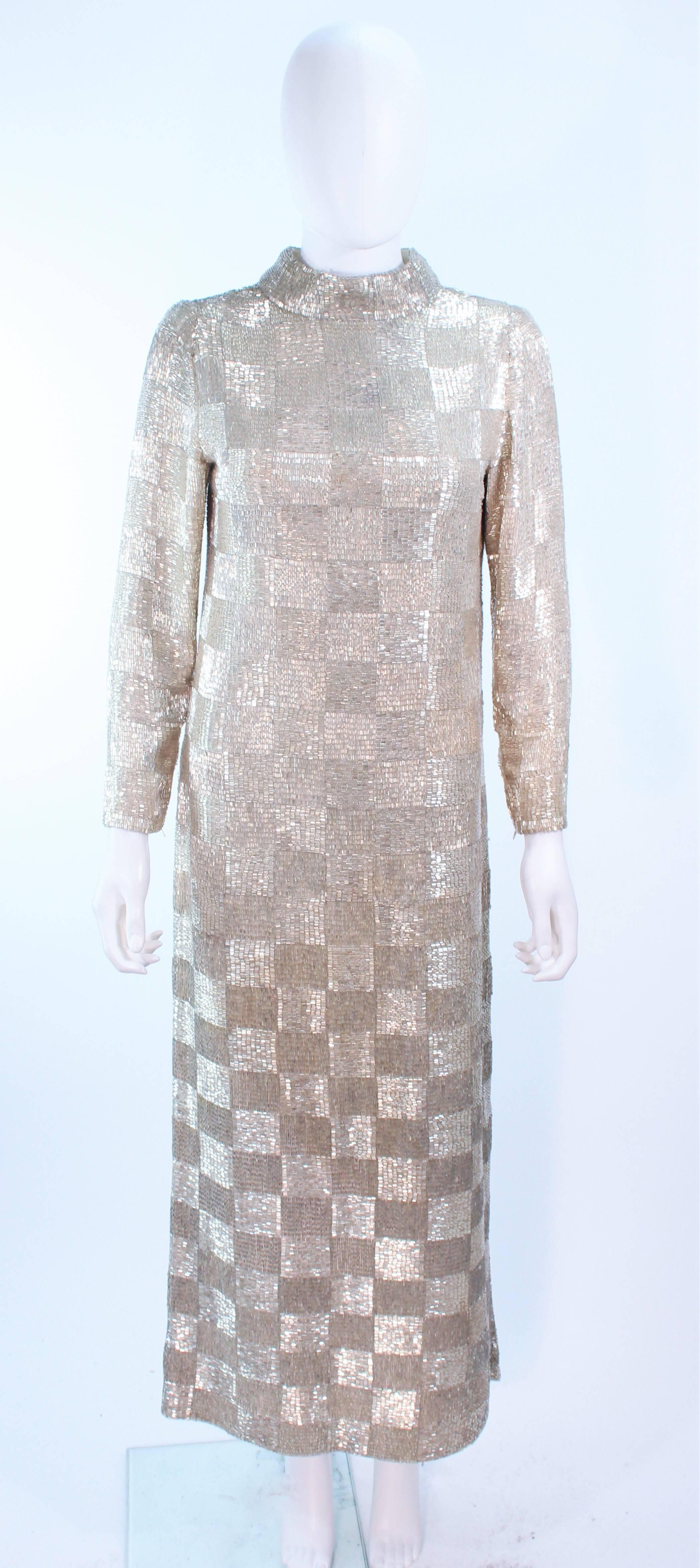 This Donald Brooks gown is composed of hand-beaded, silver beading in a checkerboard pattern. The interior lining has some staining and could use replacement, or cleaning. There is a center back zipper closure. This gown is shown with the zipper at