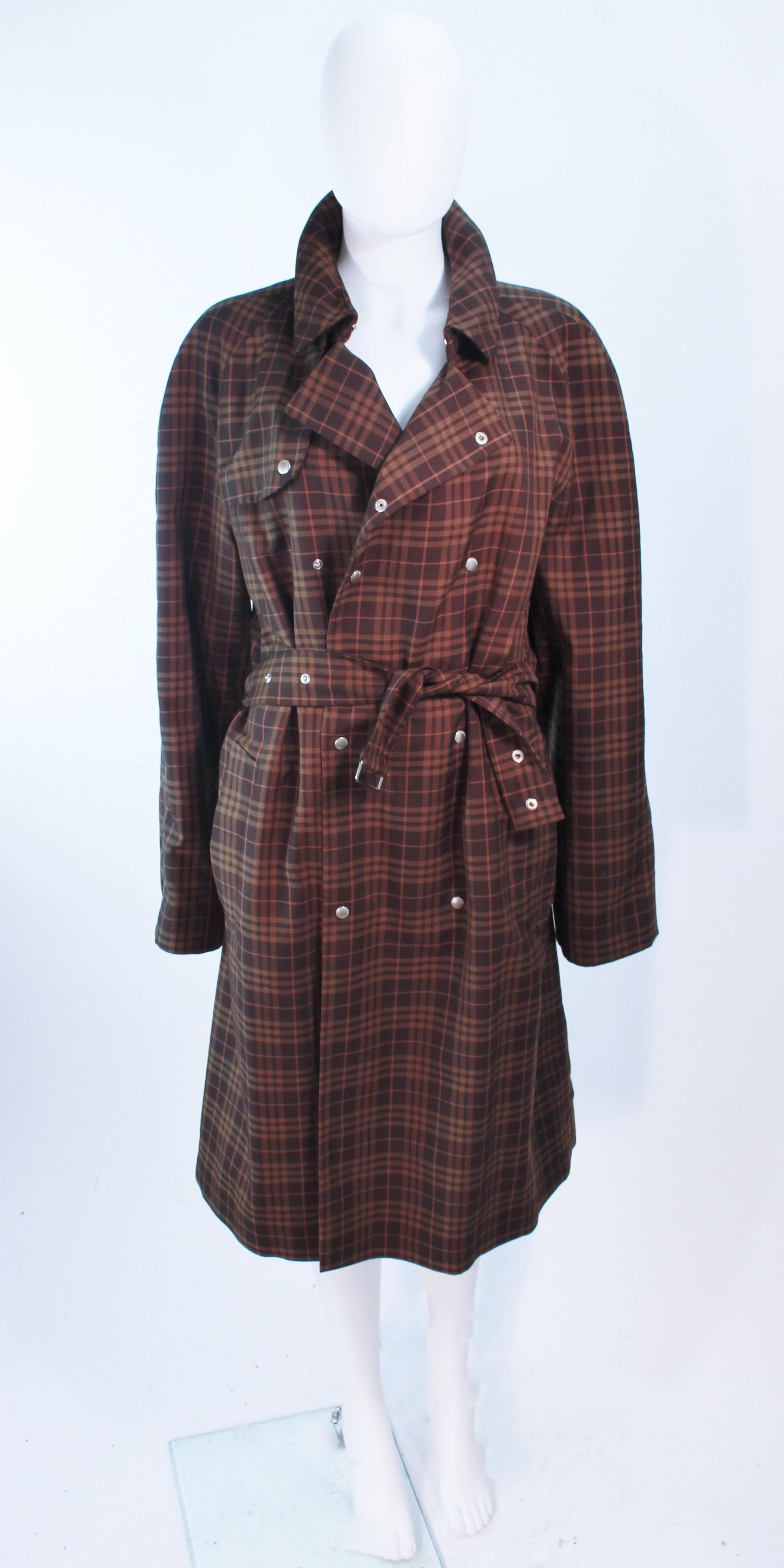 This Burberry coat is composed of a chocolate brown and drab hue plaid.  Has center front snap closures with a double breasted style and belt  In excellent vintage condition.

**Please cross-reference measurements for personal accuracy. Size in